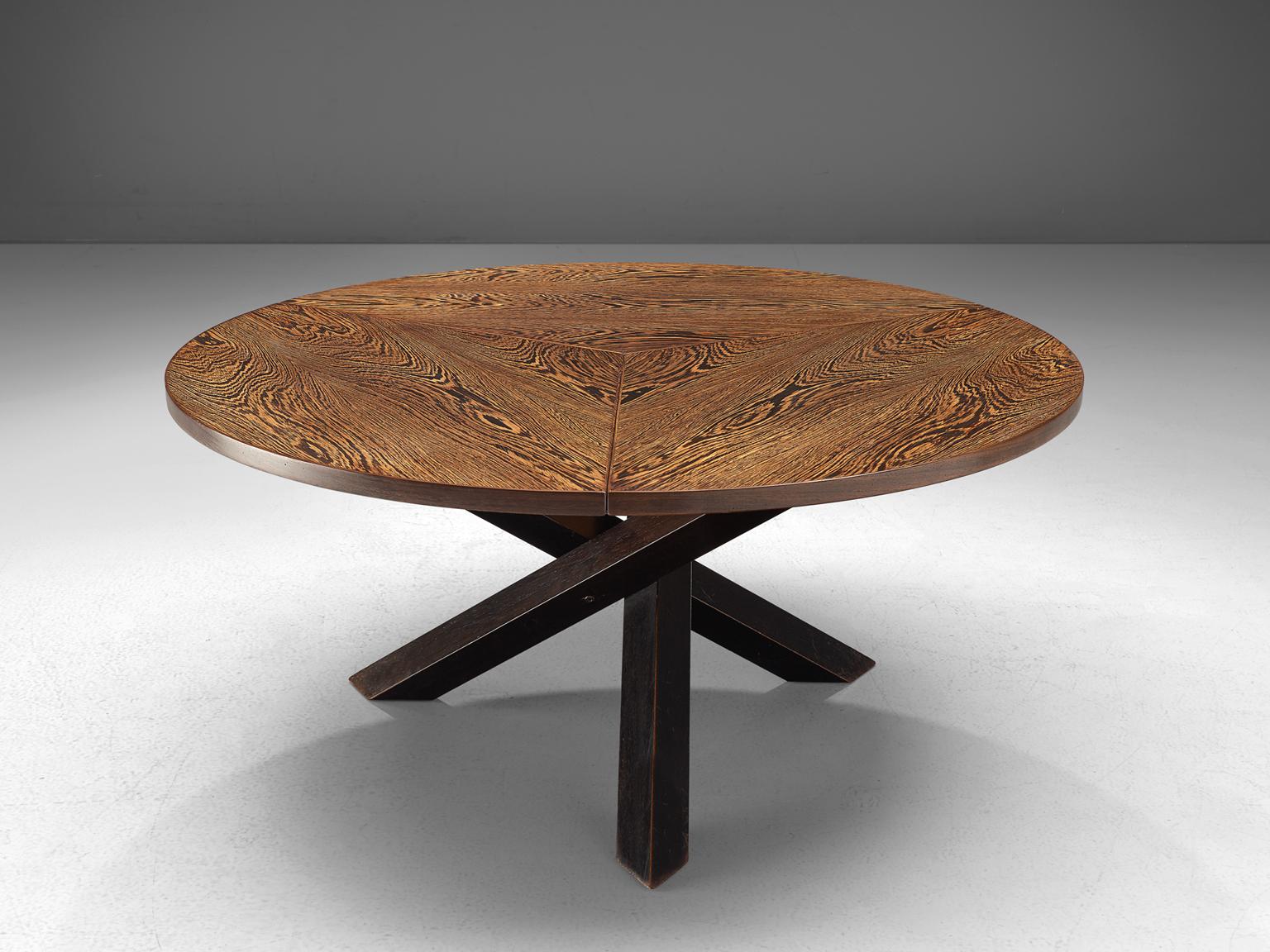 Dining table, in Wenge´, by Martin Visser for 't Spectrum, the Netherlands, 1960s. 

Beautiful patinated dining table with round top, divided into three parts. The base consist of three crossed legs of solid, dark stained wood. The veneer top