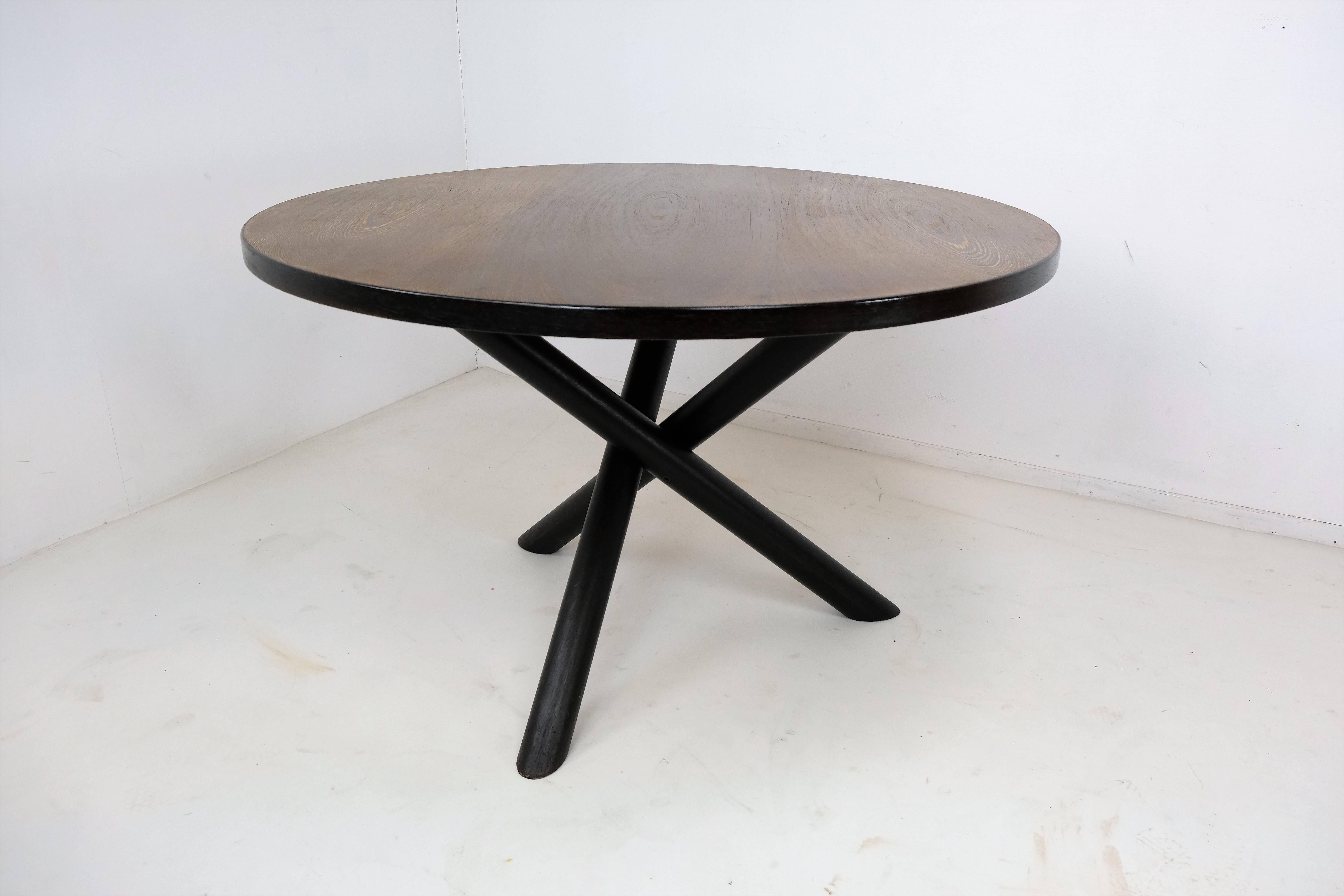 Dining table in wengé by Martin Visser for t Spectrum, the Netherlands, 1960s.

Round dining table with tripod base. This dining table has an interesting base, three legs are combined into a solid construction. A natural expression is created by