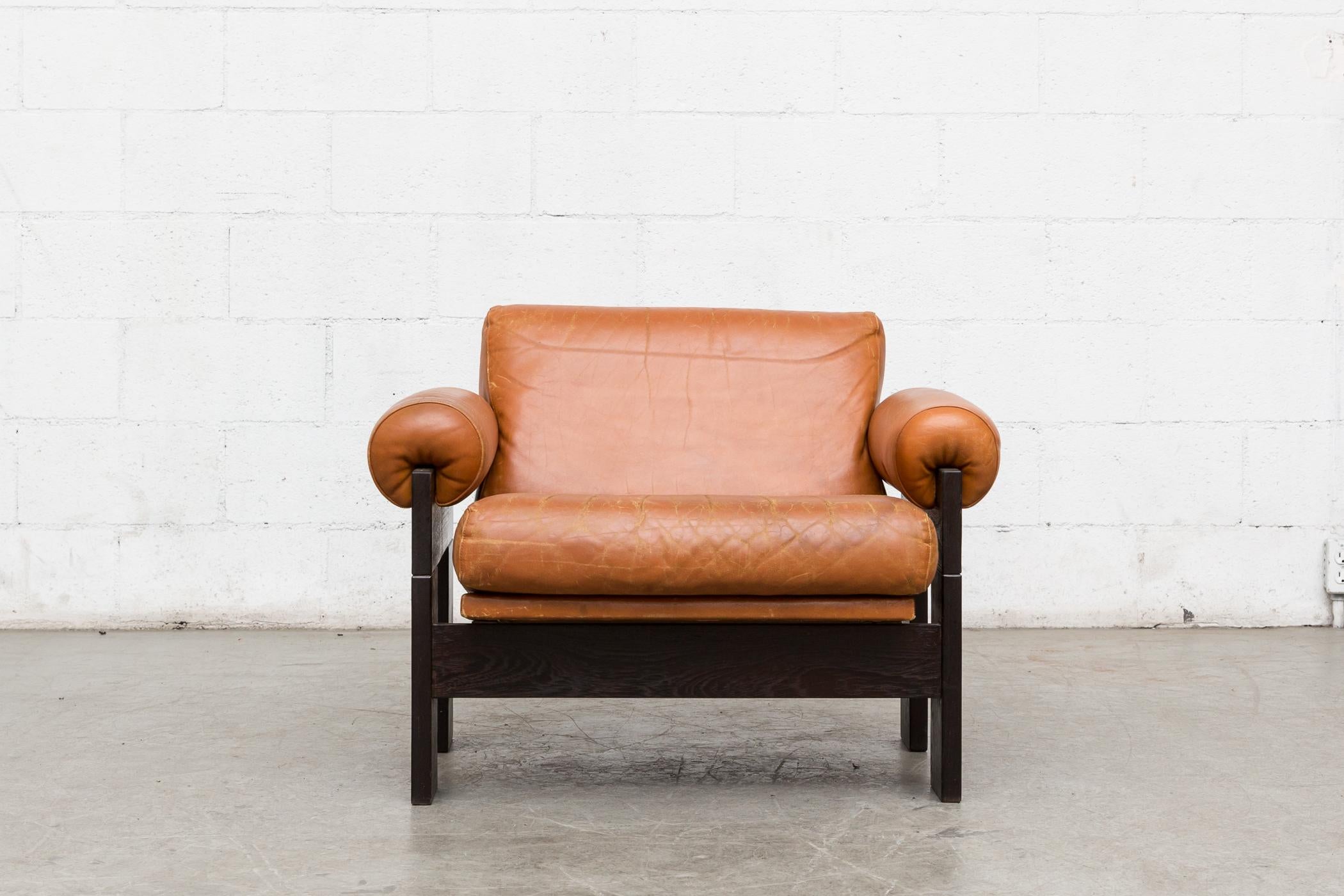 Handsome rust leather and wenge lounge chair by Martin Visser for t'Spectrum, 1970s, Holland. In very original condition with visible wear and cracking to the leather. Wear consistent with age and use.