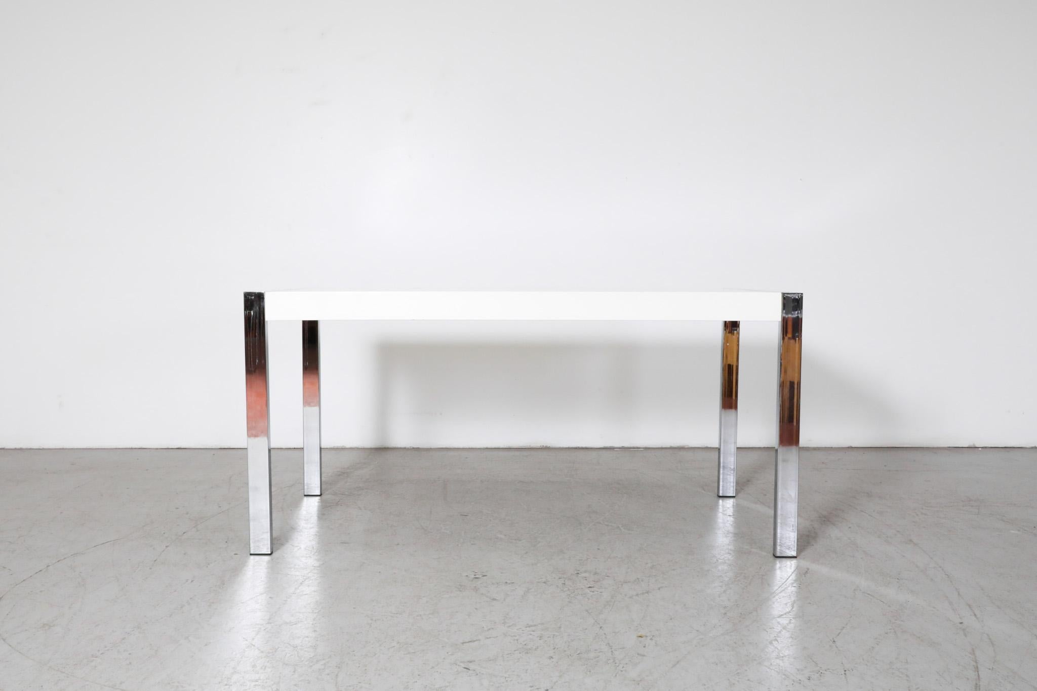 Modernist, nineteen sixties dining table or desk with attractive white Formica top and a polished chrome frame. Reminiscent of the designs Dutch mid-century designer Martin Visser. In original condition with some visible wear, including small