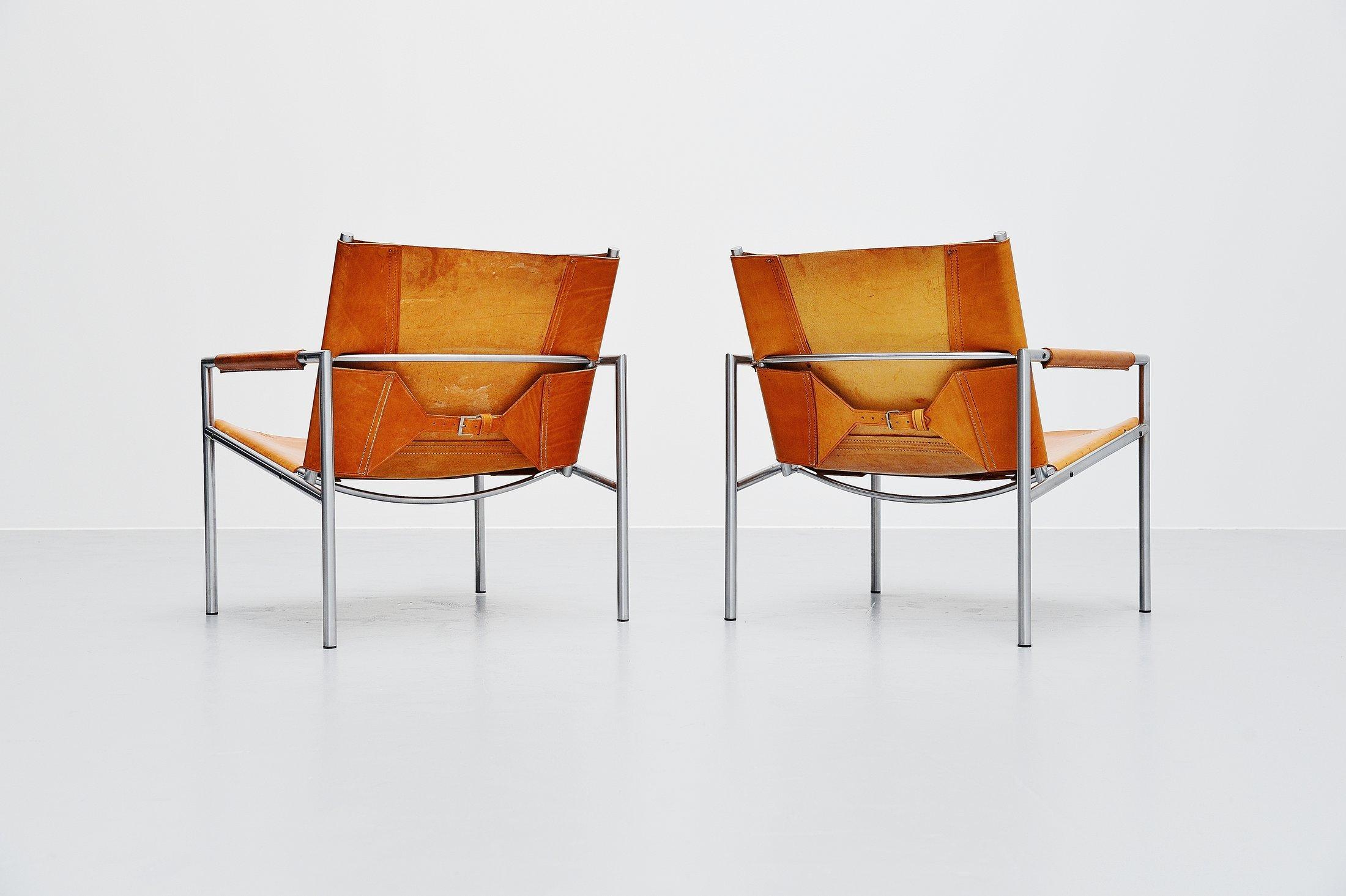 Fantastic patinated pair of lounge chairs model SZ01 designed by Martin Visser for ‘t spectrum, Holland, 1965. These chairs have a brushed steel tubular frame and very thick natural saddle leather seats and arm rests finishing. The natural leather