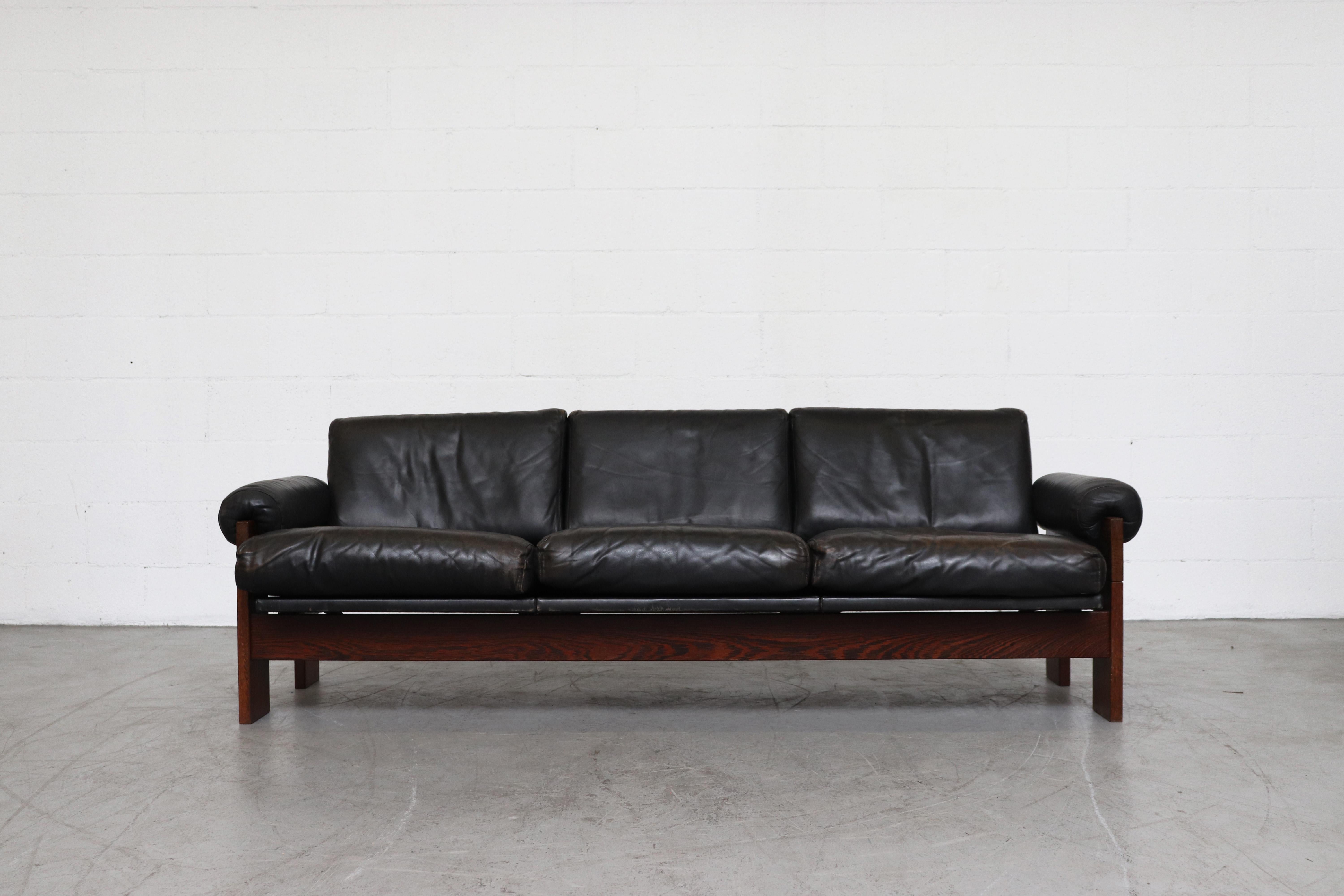 Handsome Martin Visser for 't Spectrum wenge and black leather 3-seat sofa. Featuring round padded leather armrests and heavy wenge frame. Similar to the Tobia Scarpa sofa. In original condition with some visible signs of wear consistent with age