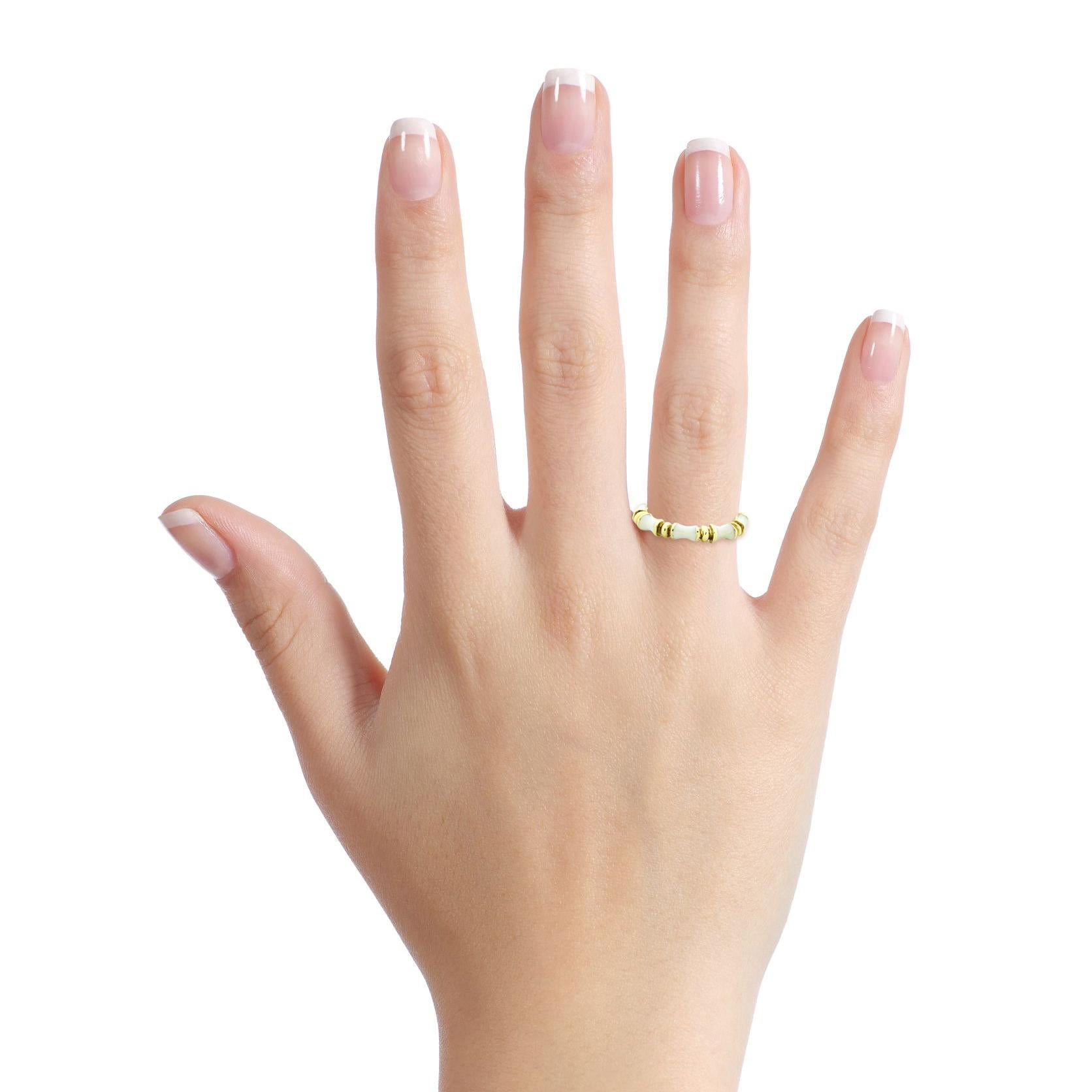 Martine white enamel band ring in 14-karat yellow gold. 

Size, 7.5
Width, 3.5mm
Depth, 3mm
Weight, 4.7 grams 