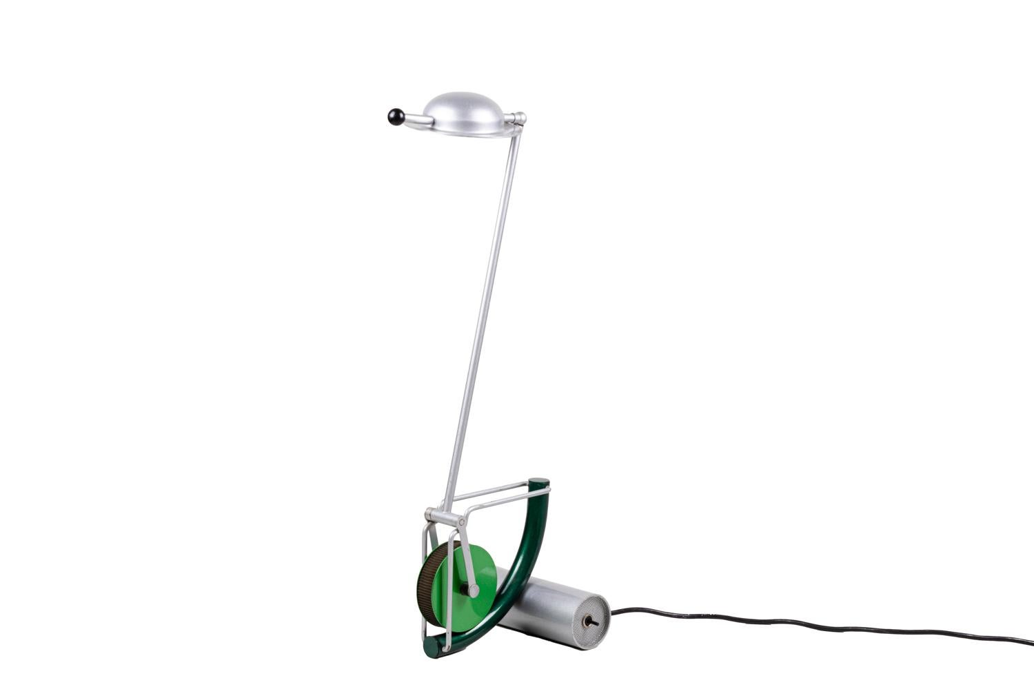 Martine Bedin, attributed to.
“Light” lamp in metal and plastic with a small half-spherical lampshade, movable thanks to the small joystick with a black round end. Shaft composed by a simple stick, movable thanks to a green plastic wheel system,