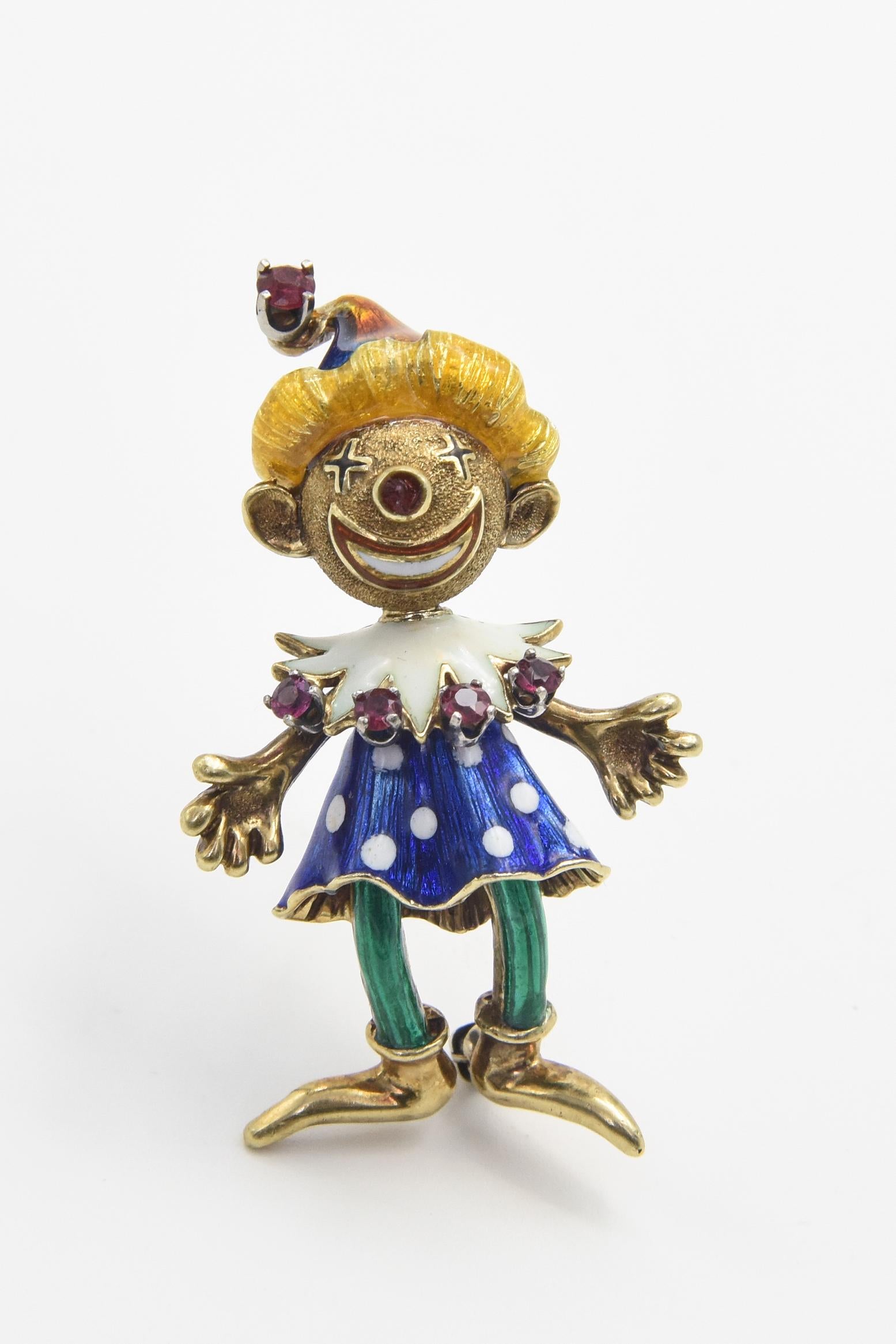 Adorable Martine 14k yellow gold brooch featuring a girl clown with a head and shoulders that jiggle her smiling face. She is wearing a blue dress with white polka dots with a white collar and ruby tips and green tights. Her head has yellow flowing