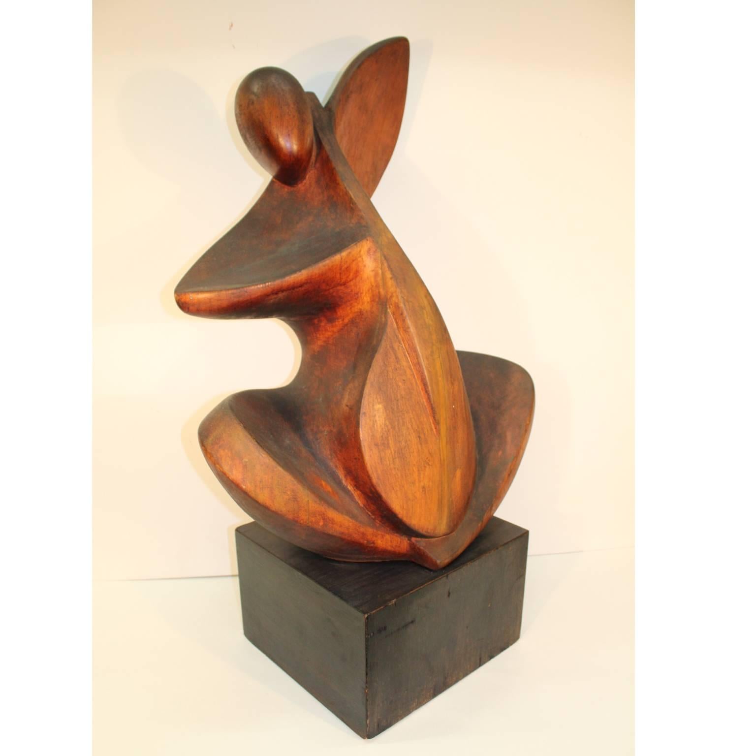 A carved walnut abstract sculpture of a Cello player by artist Joseph Martinek (American/Czech, 1915-1989), wood handcrafted during the 1930s-1940s in Chicago. The artists signature is on the back. Original stress cracks in front.
