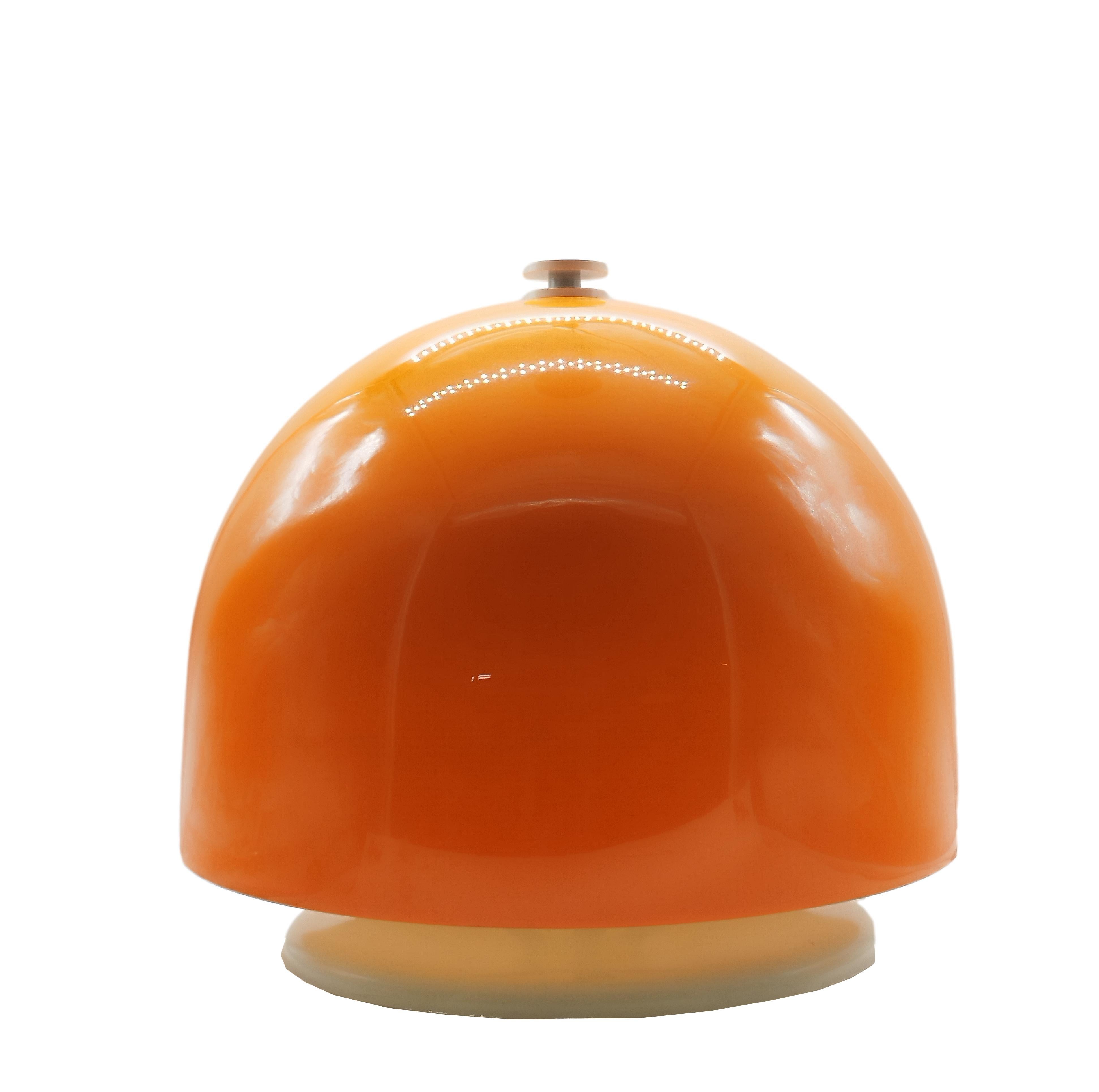 Space mushroom-shaped table lamp composed of an oversized domed shade of orange acrylic supported by a circular base of white painted metal.  Attrib. to Elio Martinelli for Martinelli Luce.
Very good vintage condition.