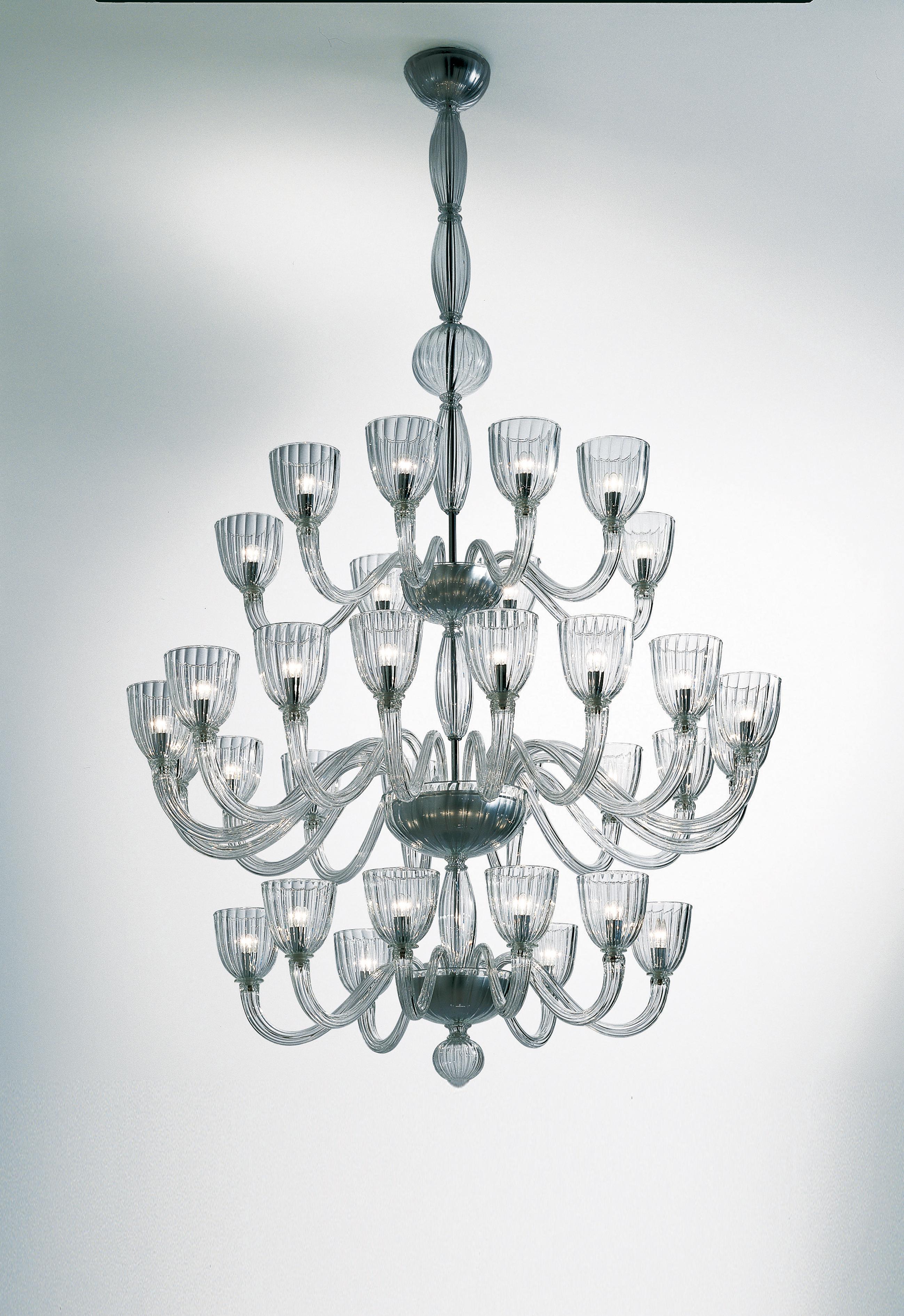 Chandelier in handmade blown glass with chromium plated metal finishes. Its size and shape make it an elegant and large statement to any room. 

Light source: 32 lights x max 60 W E14. Dimensions: 143 cm diameter x 233 cm height.