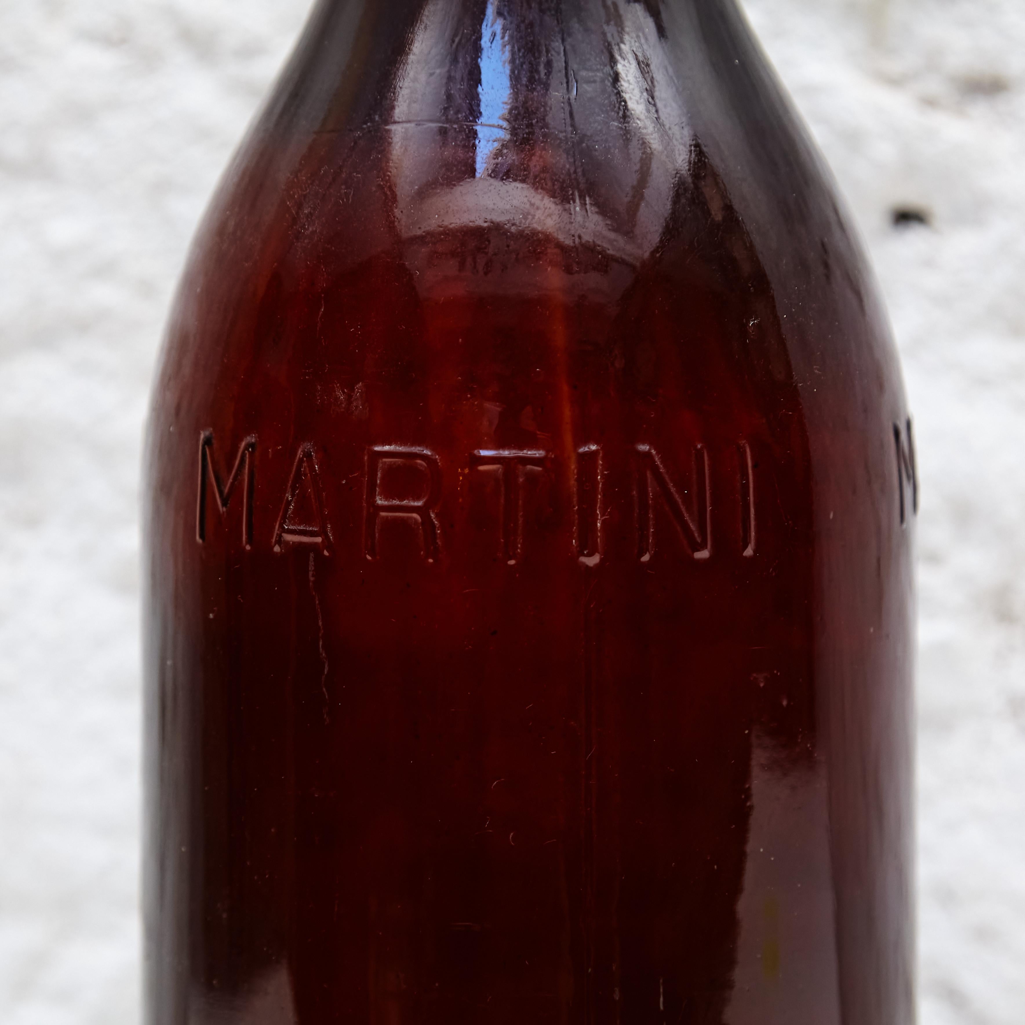 Big Martini glass bottle for French advertising.

Manufactured in France, circa 1940.

In good original condition, with consistent with age and use, preserving a beautiful patina with some scratches.

Dimensions: 
Diameter 15 cm x Height 54