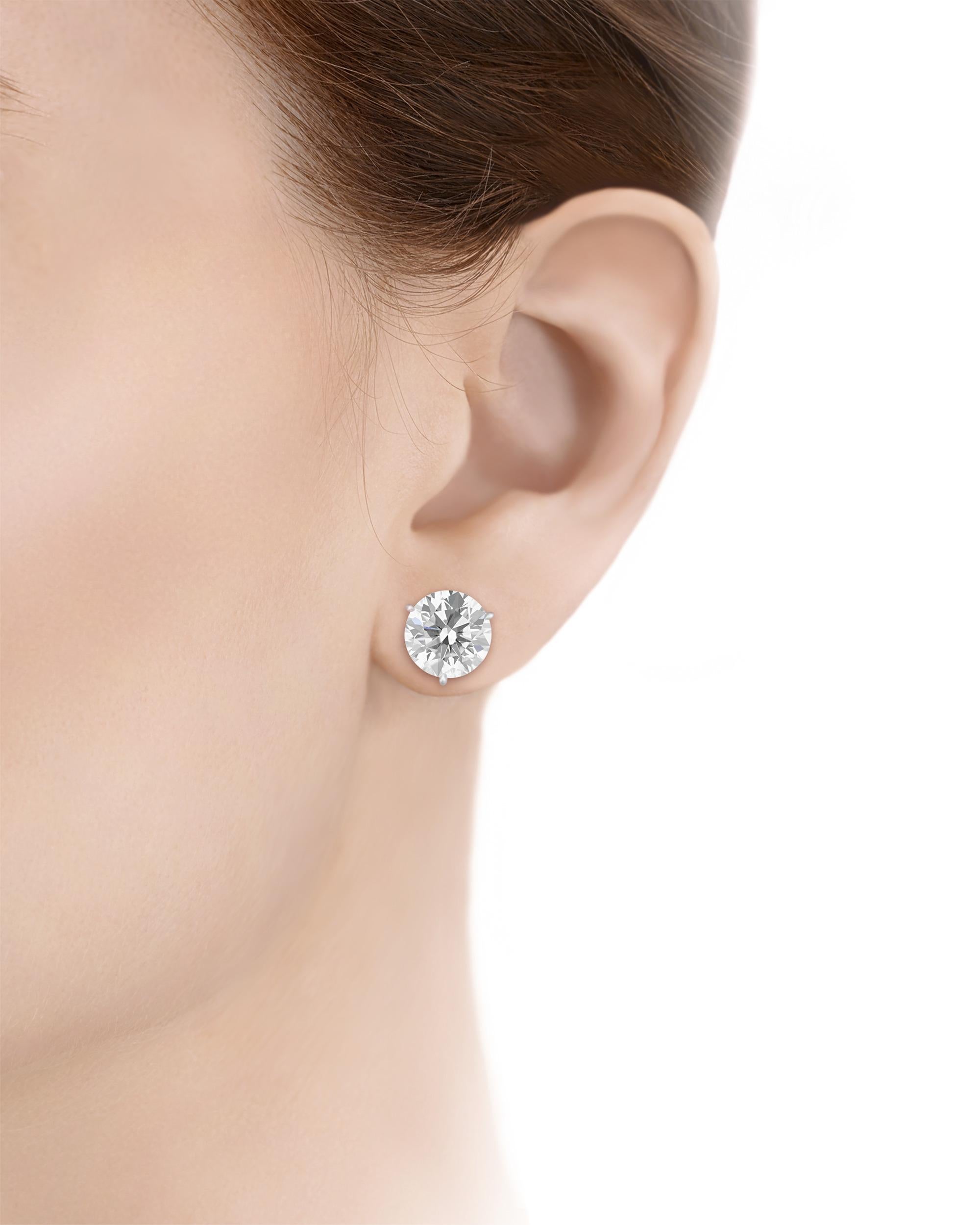 Exuding a timeless elegance, these diamond earrings make a statement. Two round brilliant-cut white diamonds, weighing 5.00 and 5.01 carats respectively, form the focal point of the earrings. Certified by the Gemological Institute of America, each