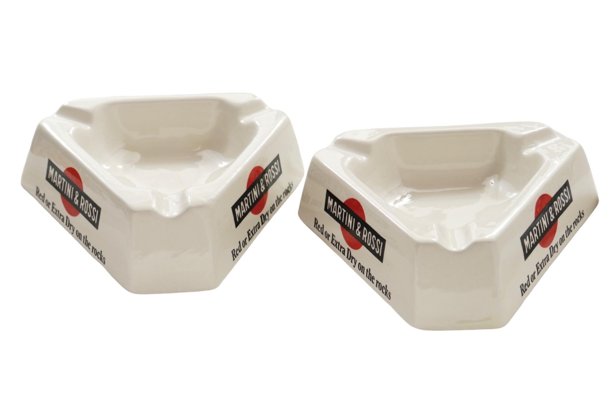 A pair of French Martini & Rossi triangular ceramic ashtrays. White ceramic reads 