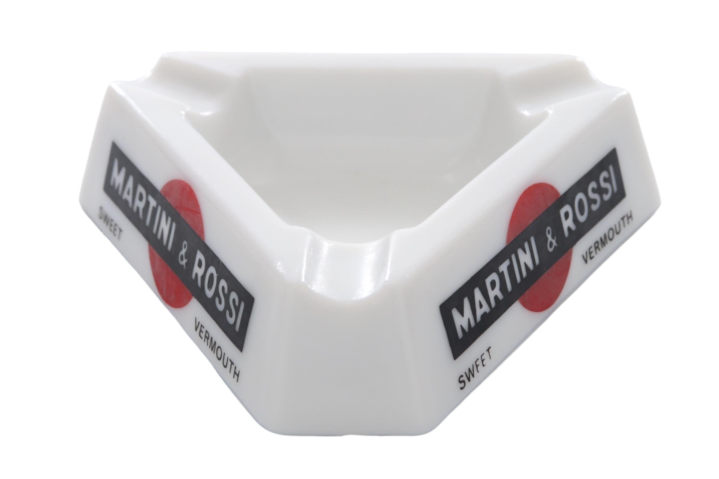 A pair of French Martini & Rossi triangular ashtrays. White Opalex is branded Martini & Rossi Sweet Vermouth on each side. Each corner has a beveled cigarette rest. Marked “Made in France, Renfield Importers, New York, NY” underneath. Dimensions per
