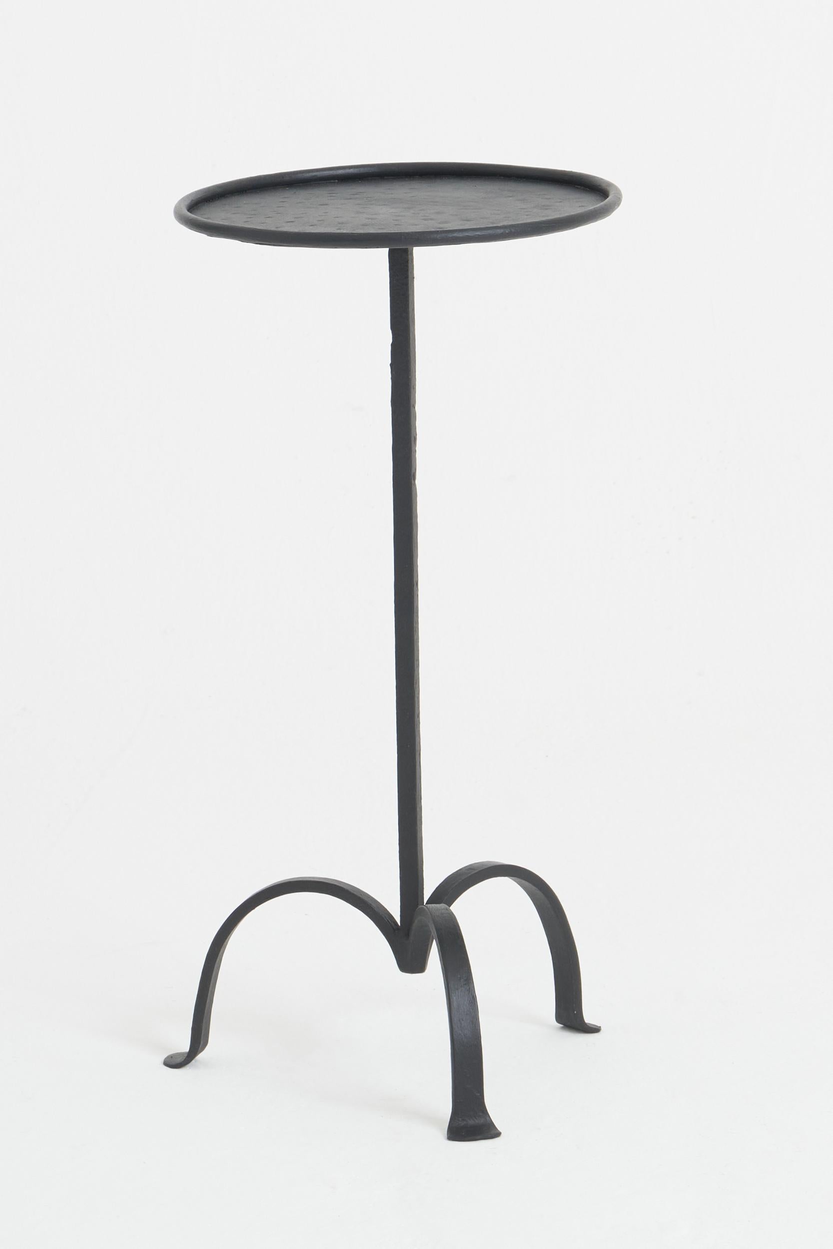 A black patinated wrought iron martini table.
Spain, mid 20th century
52 cm high by 26 cm diameter.