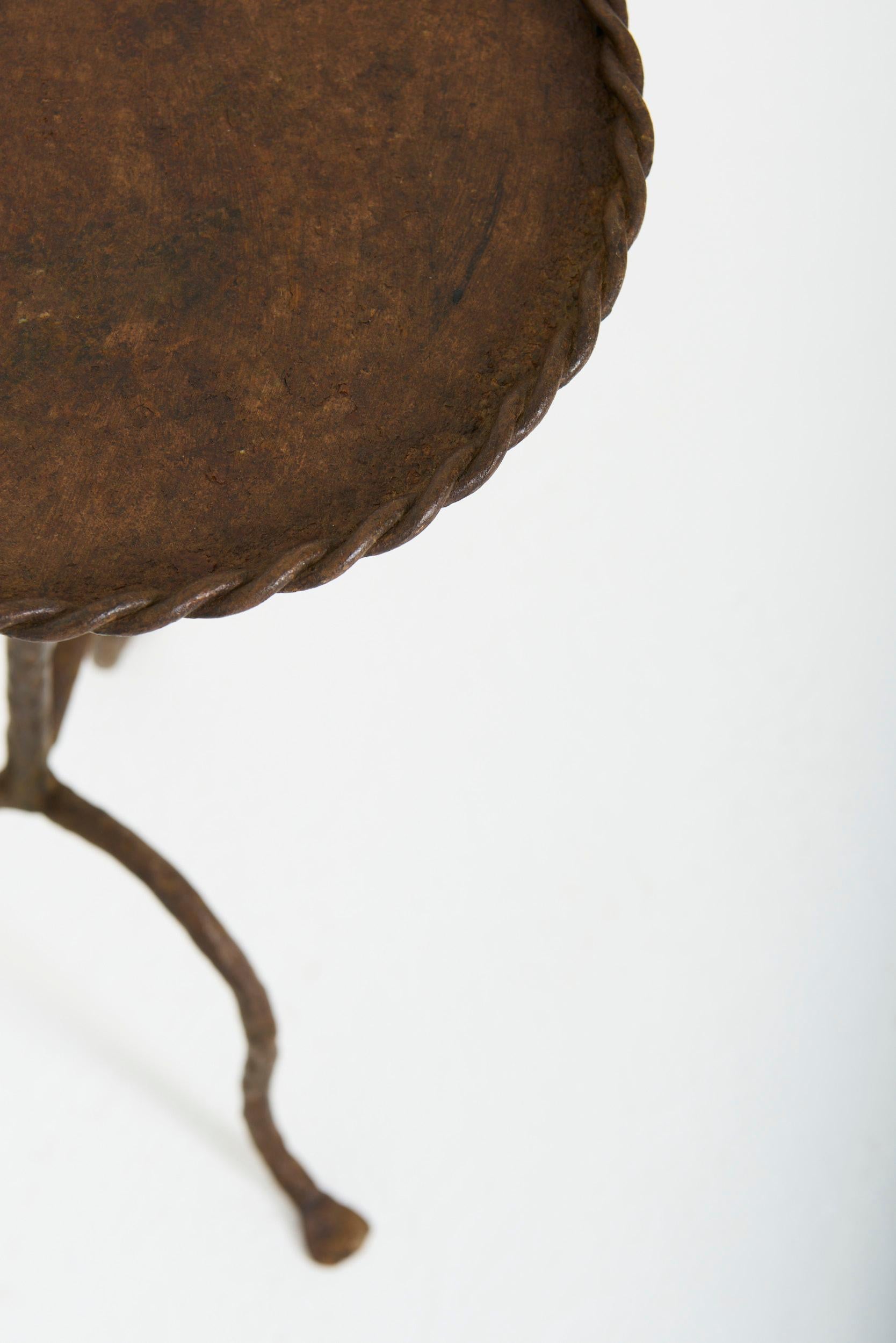 A wrought iron martini table, in its original patina
Spain, mid 20th Century
