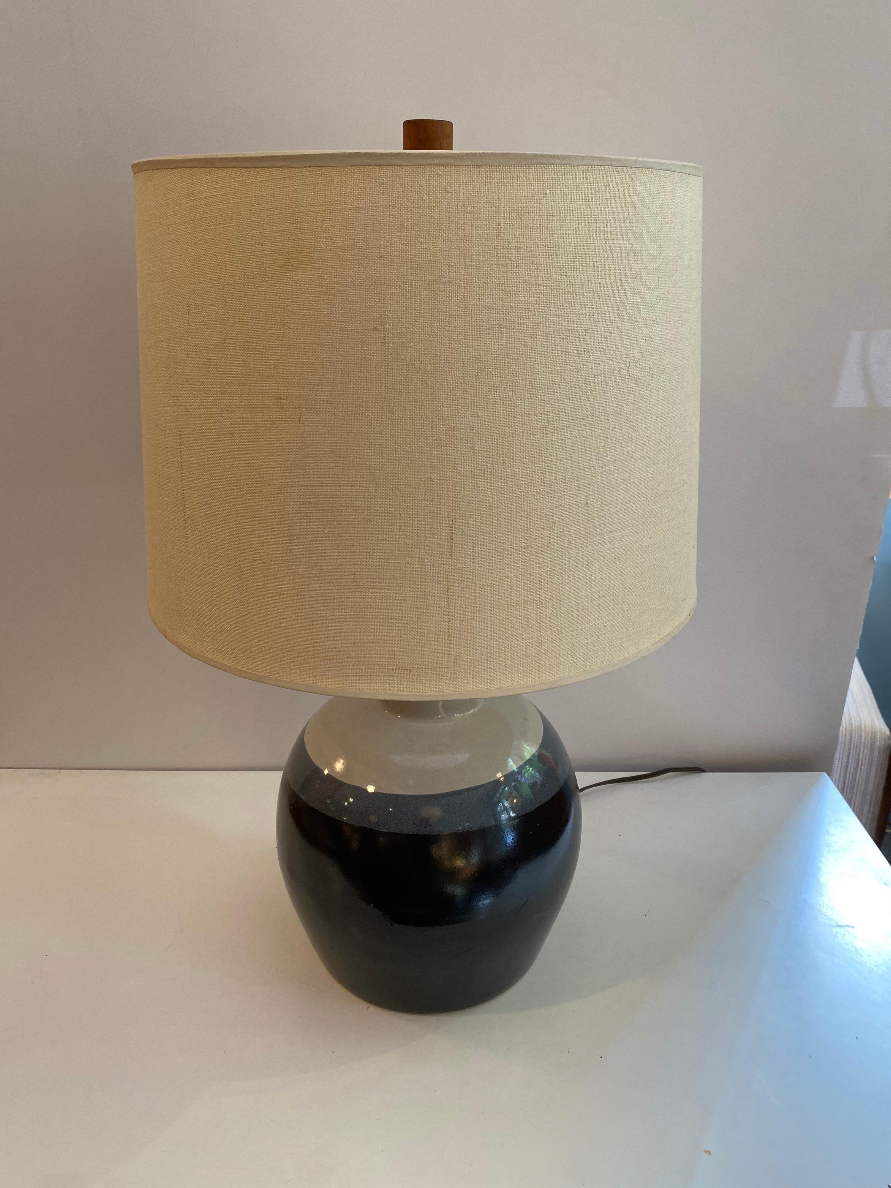 Martz ceramic table lamp with its original shade. Small walnut stem just below lamp socket and wood finale add to this Lamp. Signed to back where cord comes out of pottery. Probably dates to the late 1970's. Shape has shown up in earlier examples,