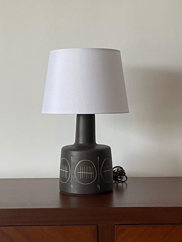 Wonderful matte dark (black with almost a slight navy hint) lamp by famed ceramicist duo Jane and Gordon Martz for Marshall Studios. Great texture, shape, and color. This lamp would work well in a variety of interiors: modern, contemporary, boho