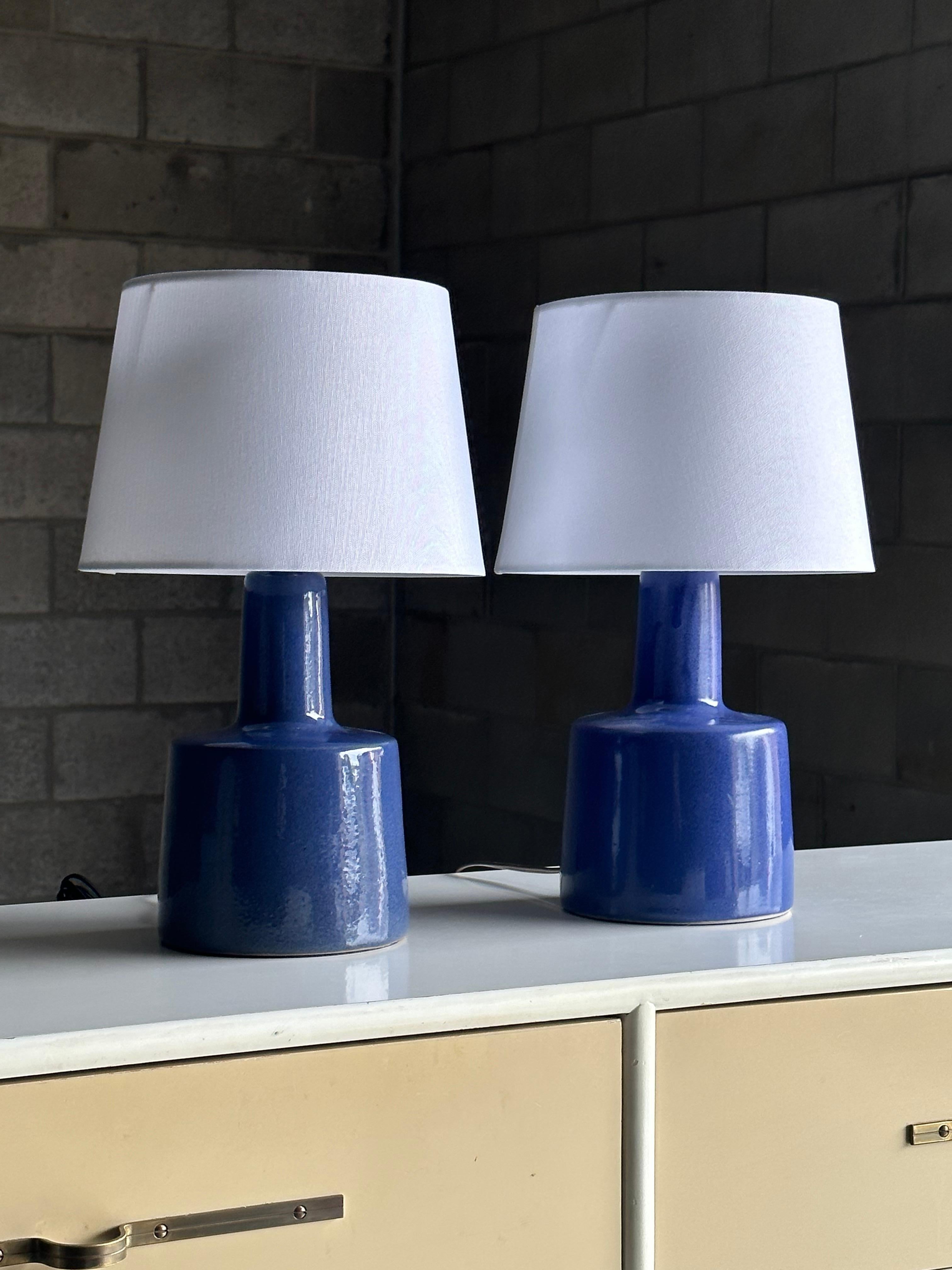 Table lamps designed by ceramicist duo Jane and Gordon Martz for Marshall Studios. Color is royal blue. Please note these are not an exact color match, they are exceptionally close in color as can be seen, but were made years apart, as such the