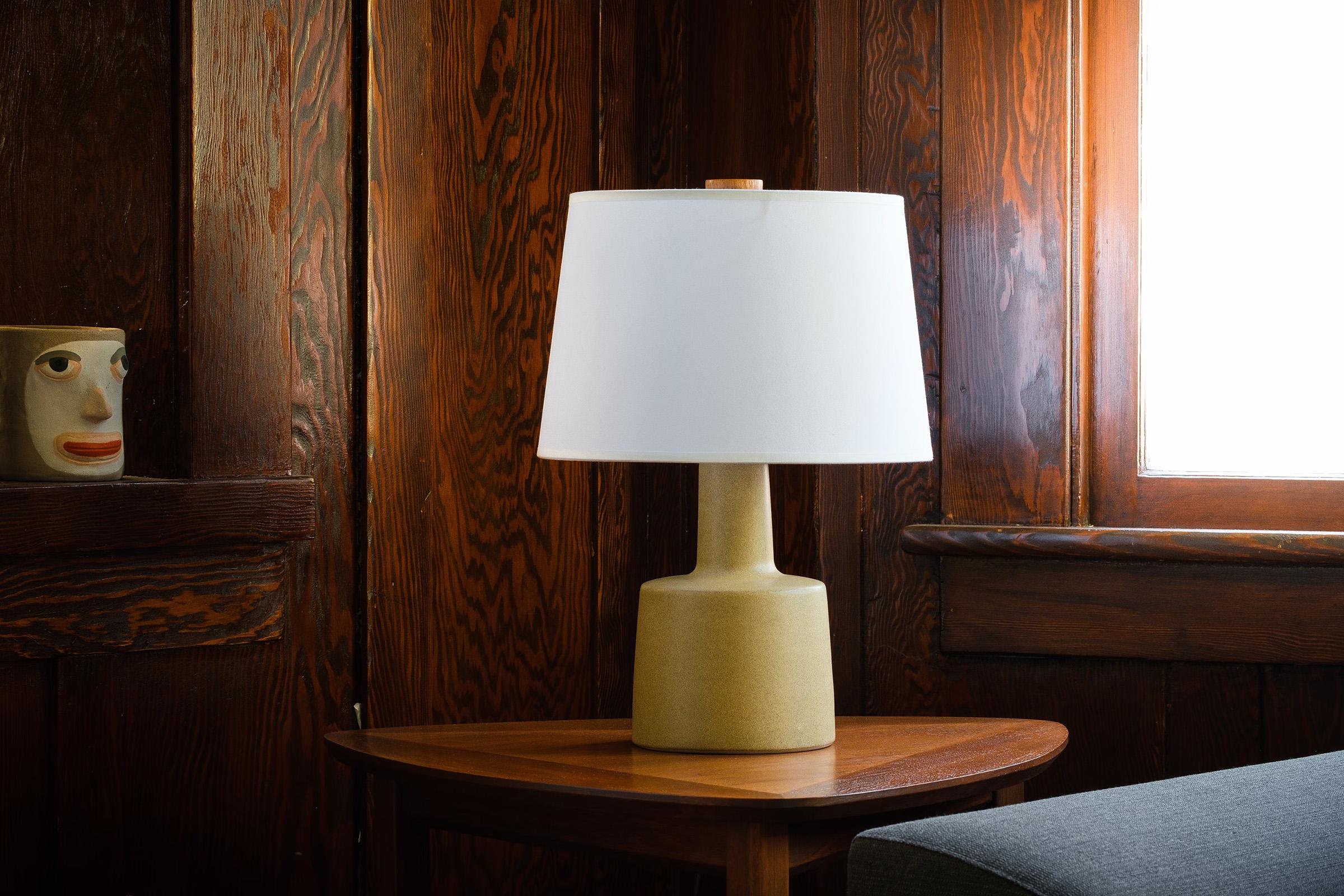 What is it?
—
Another gem from the masters of mid century lightning – Gordon and Jane Martz.

This signed Martz model 105 lamp comes in a matte yellow glaze with darker flecks and specks of browns and black. The overall color tone is hard to pin