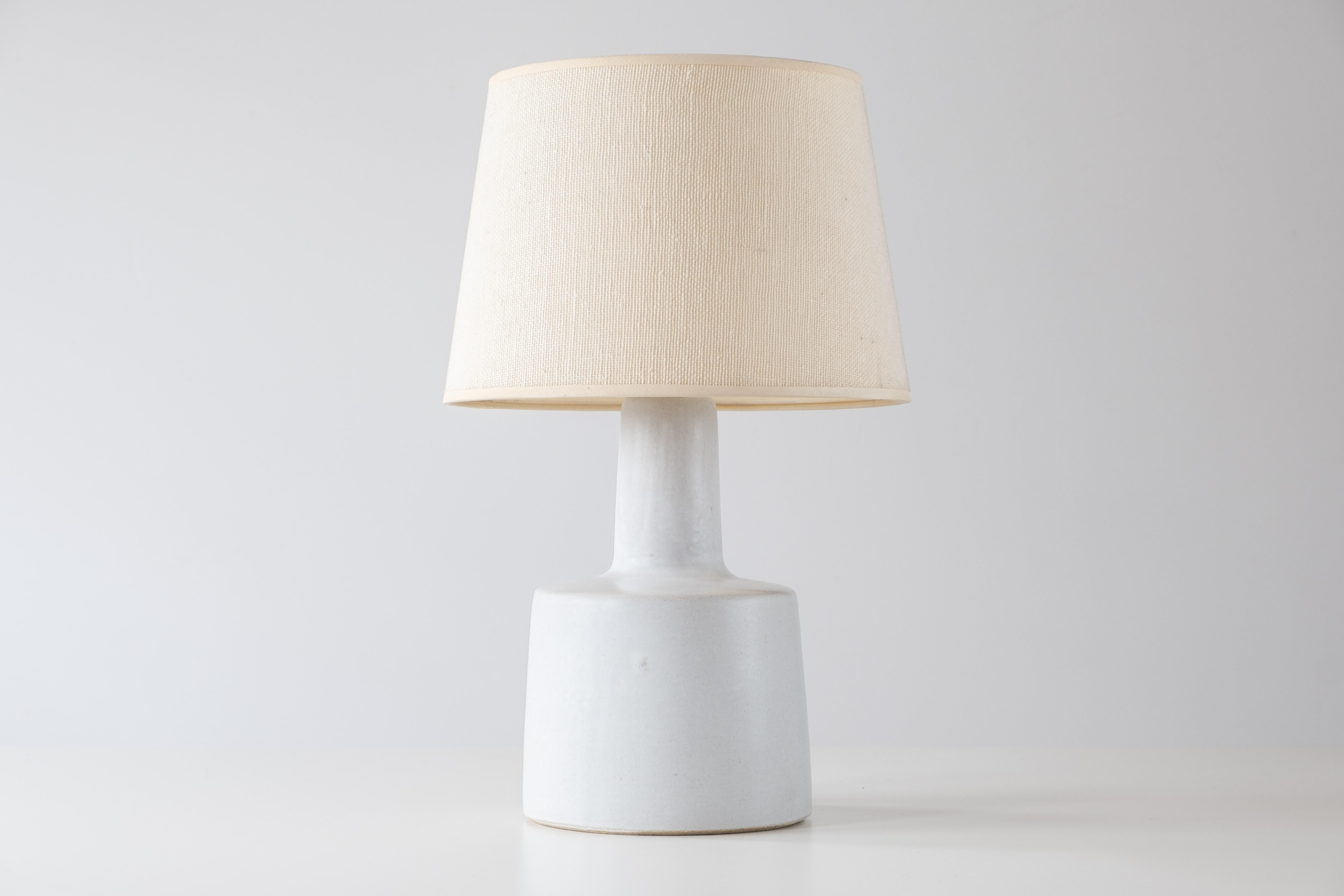 What is it?
—
Another gem from the masters of mid century lightning – Gordon and Jane Martz.

This signed Martz model 105 lamp comes in a semi-gloss white glaze with small flecks of red and blue. The lamp shows a small bit of texture from the clay