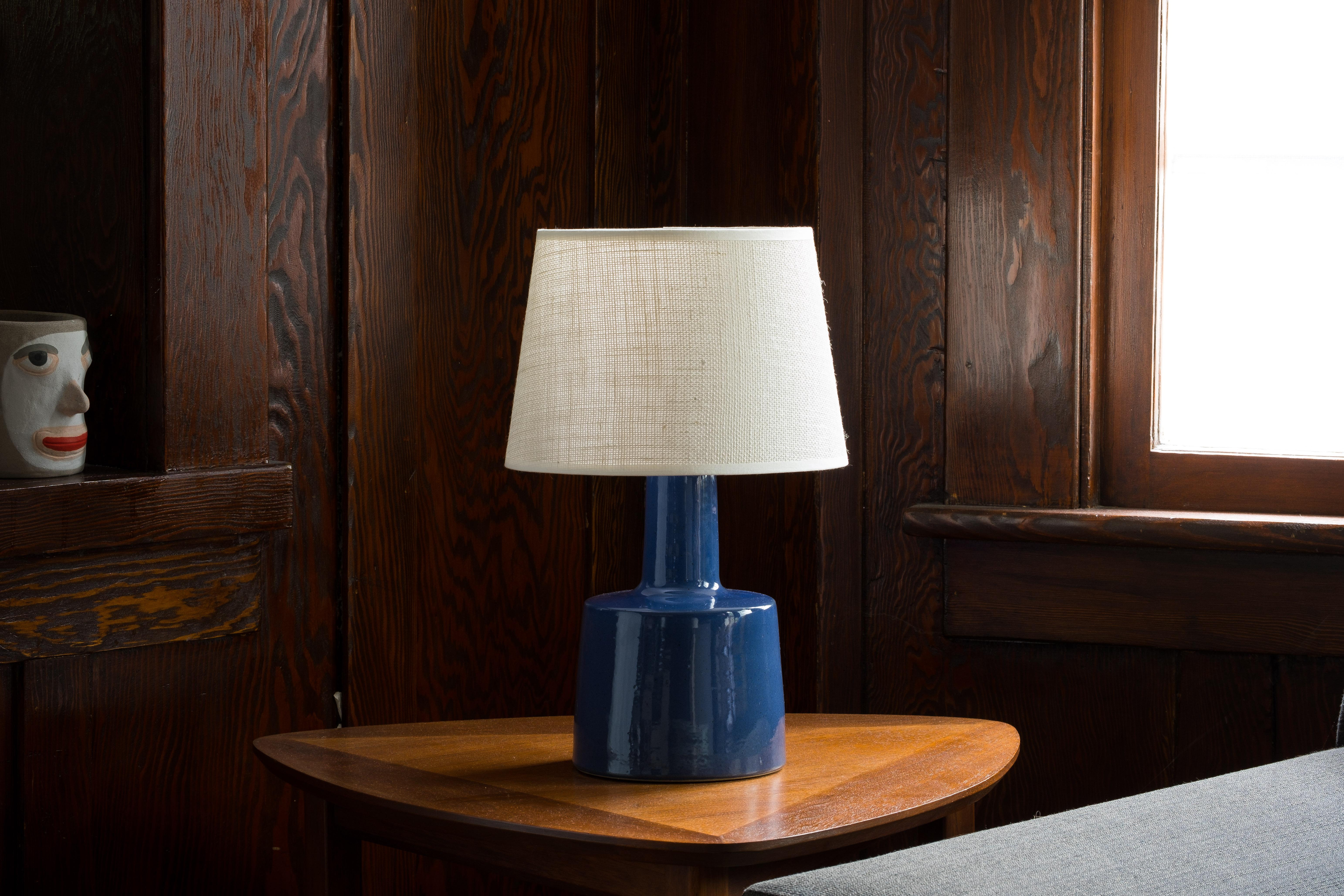 What is it?
—
Another gem from the masters of mid century lightning – Gordon and Jane Martz.

This signed Martz model 105 lamp comes in a glossy dark sapphire blue glaze with tiny flecks and specks of darker colors.

This is a beautiful piece that
