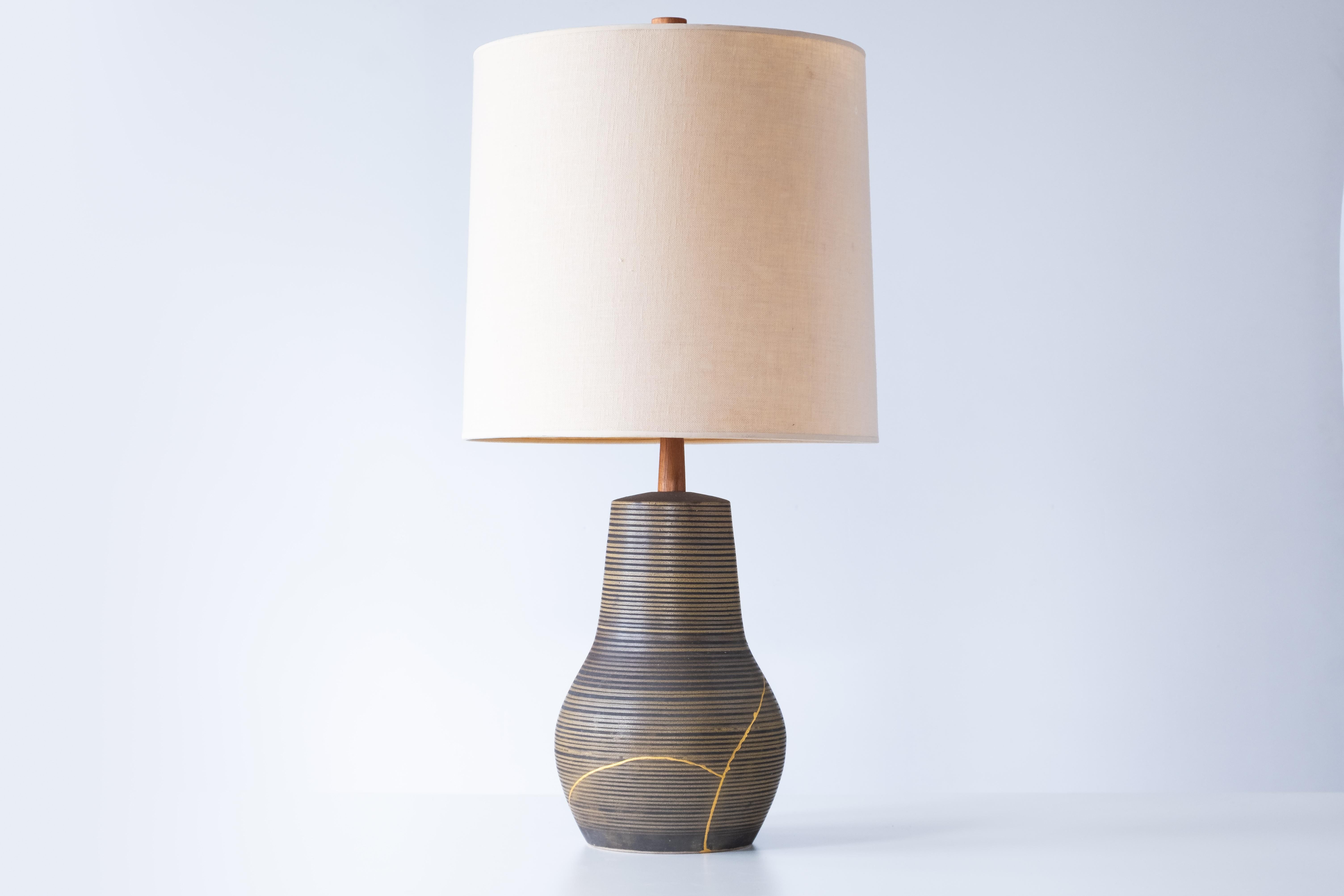 What is it?
—
This is a beautiful and unique vintage Martz ceramic lamp, expertly restored using the traditional Japanese art of kintsugi (gold repair). After being damaged in shipping, the lamp was professionally repaired by a local artisan in