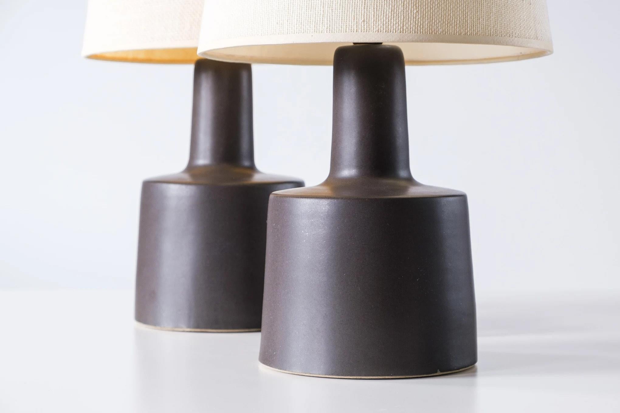 💡 WHAT IS IT?
—
Another gem from the masters of mid century lightning – Gordon and Jane Martz.

This signed pair of Martz model 105 lamps comes in a matte black/dark gray glaze. 

This set of lamps is a bit on the smaller side and will fit great on