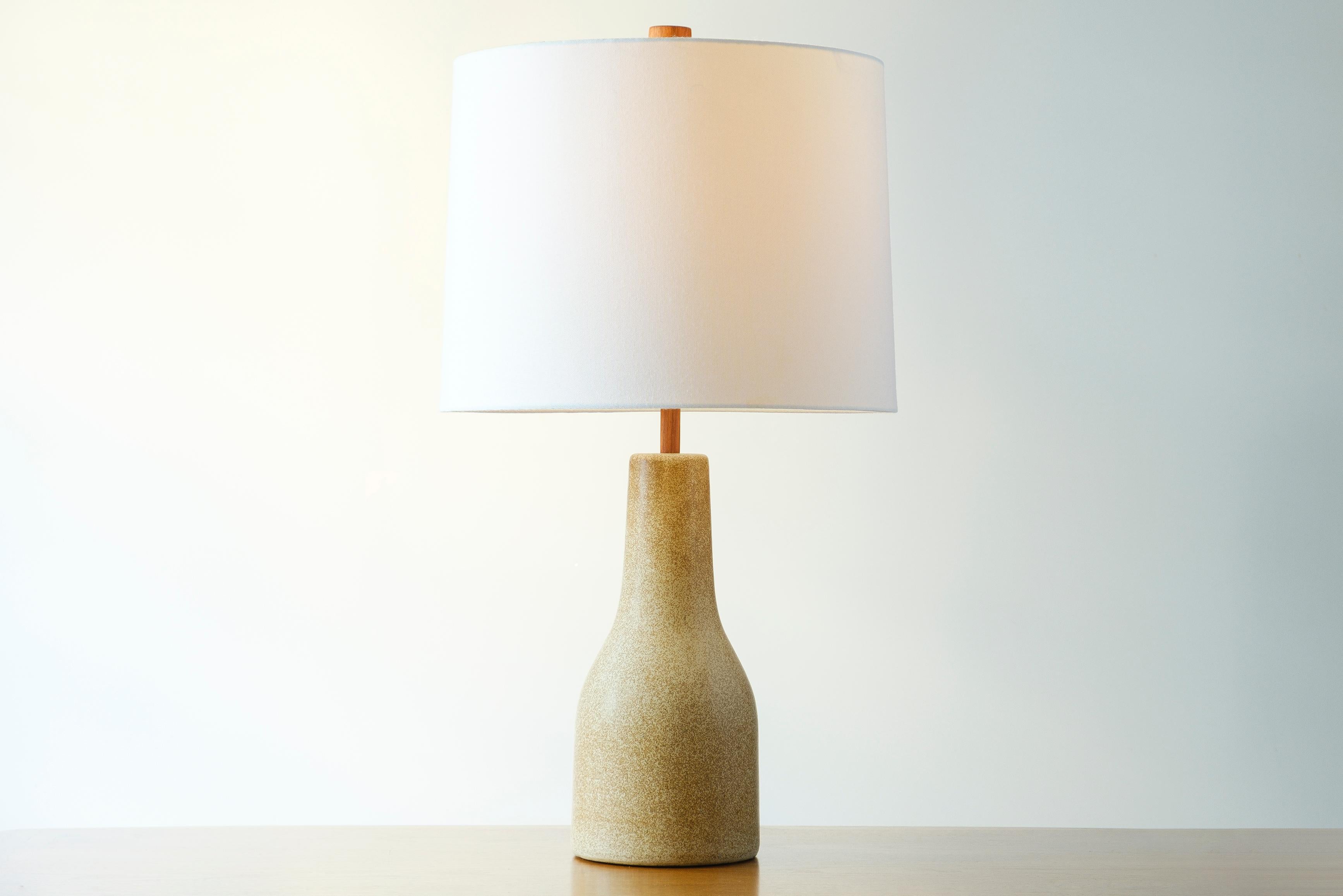 What is it?
—
Another gem from the masters of mid century lightning – Gordon and Jane Martz.

This signed Martz #84 lamp comes in a matte tan glaze with a darker flecks of color. There is a slightly green undertone to the glaze that is presents