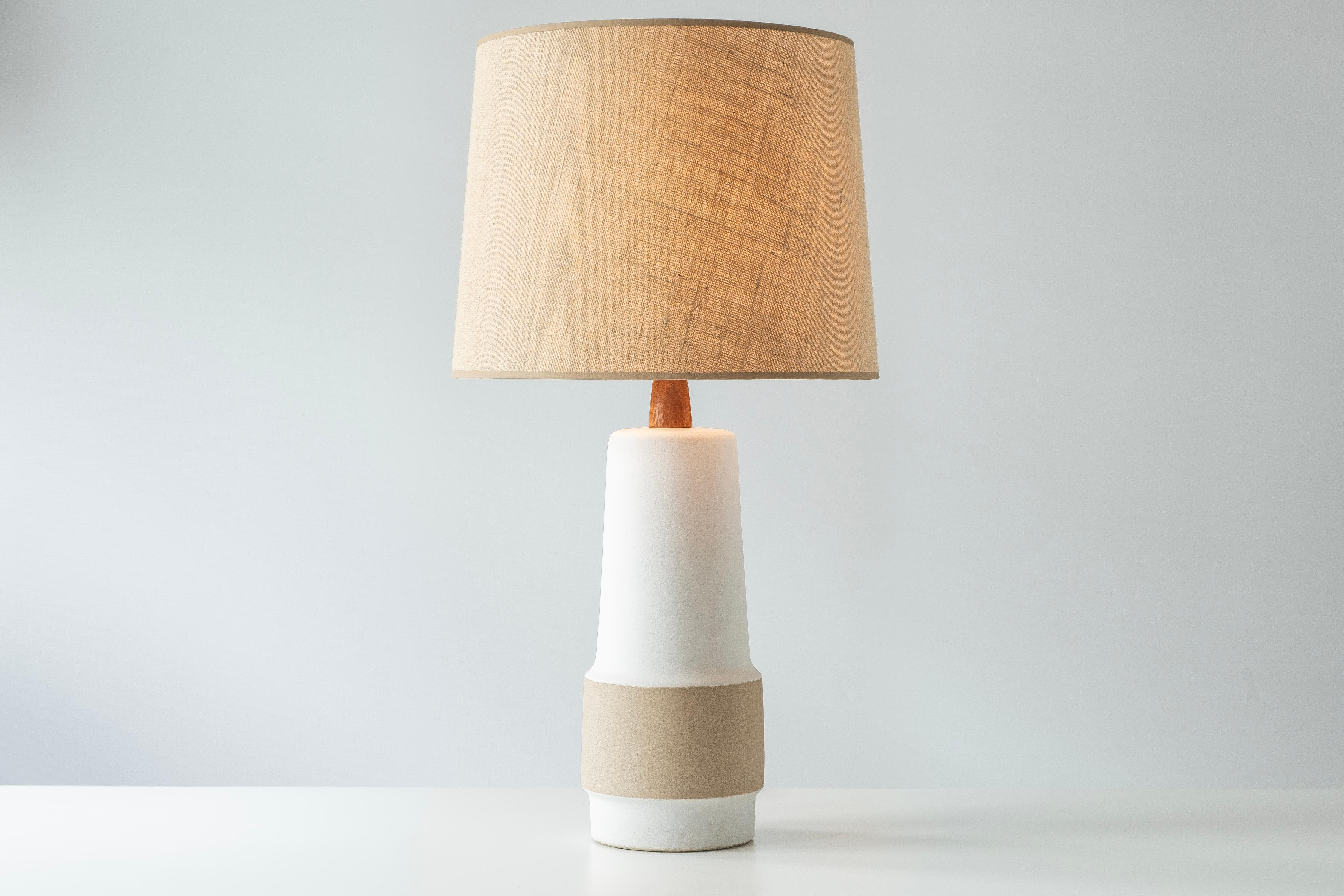 ?? WHAT IS IT?
—
This signed Martz Model 144 lamp comes in a matte, unglazed two-tone body. This model was slipcast then painted with a white slip, giving the lamp its white color. The tan stripe is the natural, unglazed clay body color. Catalog