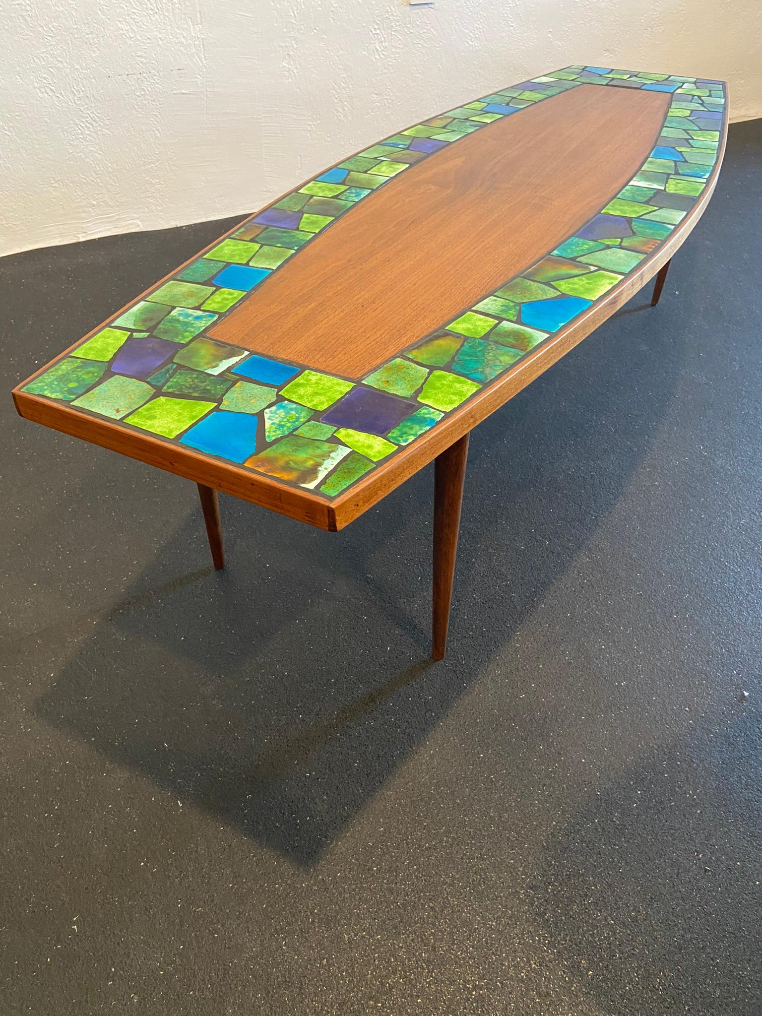 Martz style ceramic tile inlaid walnut coffee table. No makers marks. Extremely rare form. Beautiful variety of colors, shades of blues and greens. Table has been refinished.

Would work well in a variety of interiors such as modern, mid century