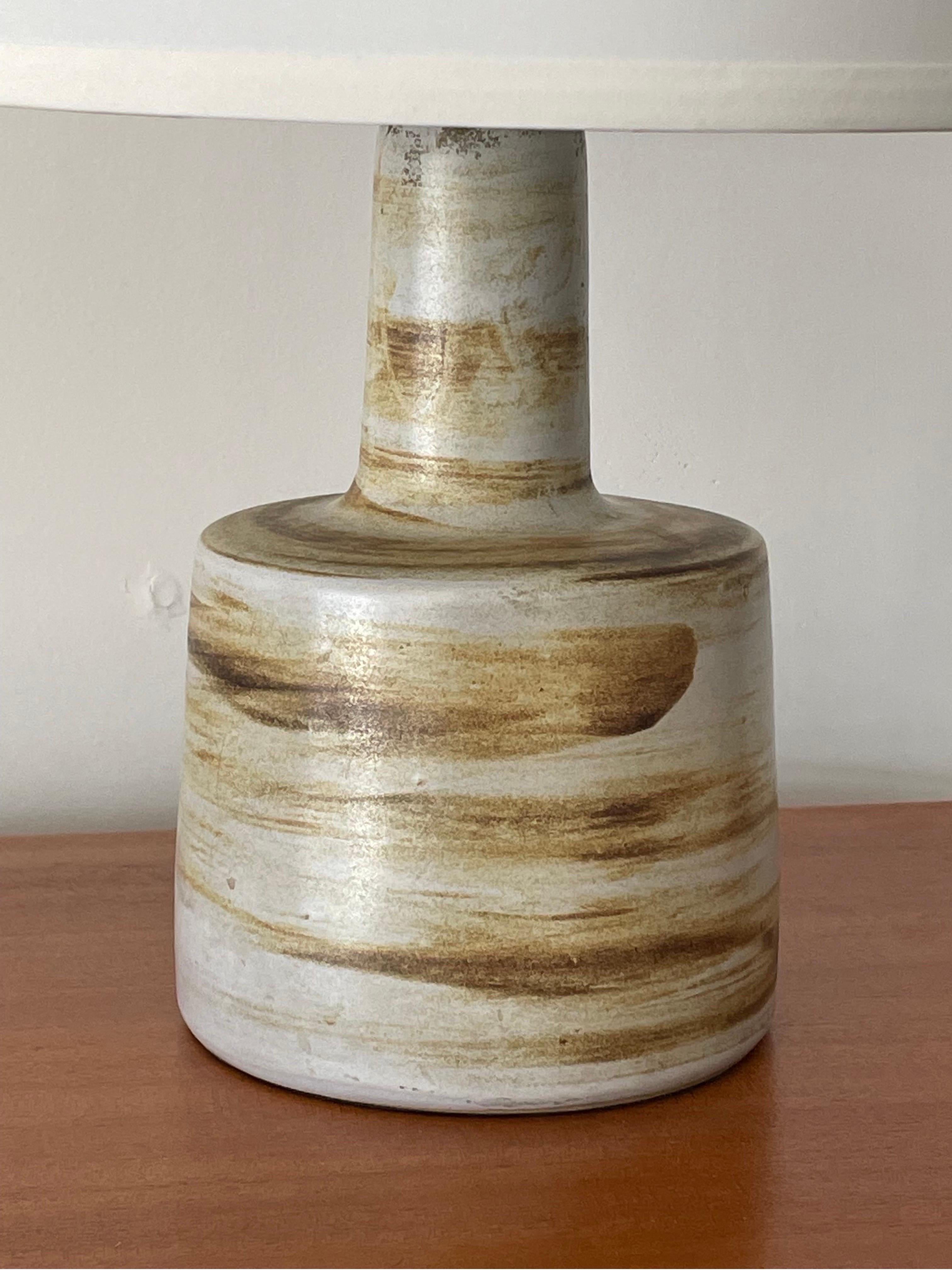Table lamp designed by famed ceramicist duo Jane and Gordon Martz for Marshall Studios. Great painted detailing with hues of yellow and brown.

Overall:
19” tall
13” wide

Ceramic:
9” tall
6.25” wide.

Shade is shown for illustrative purposes only