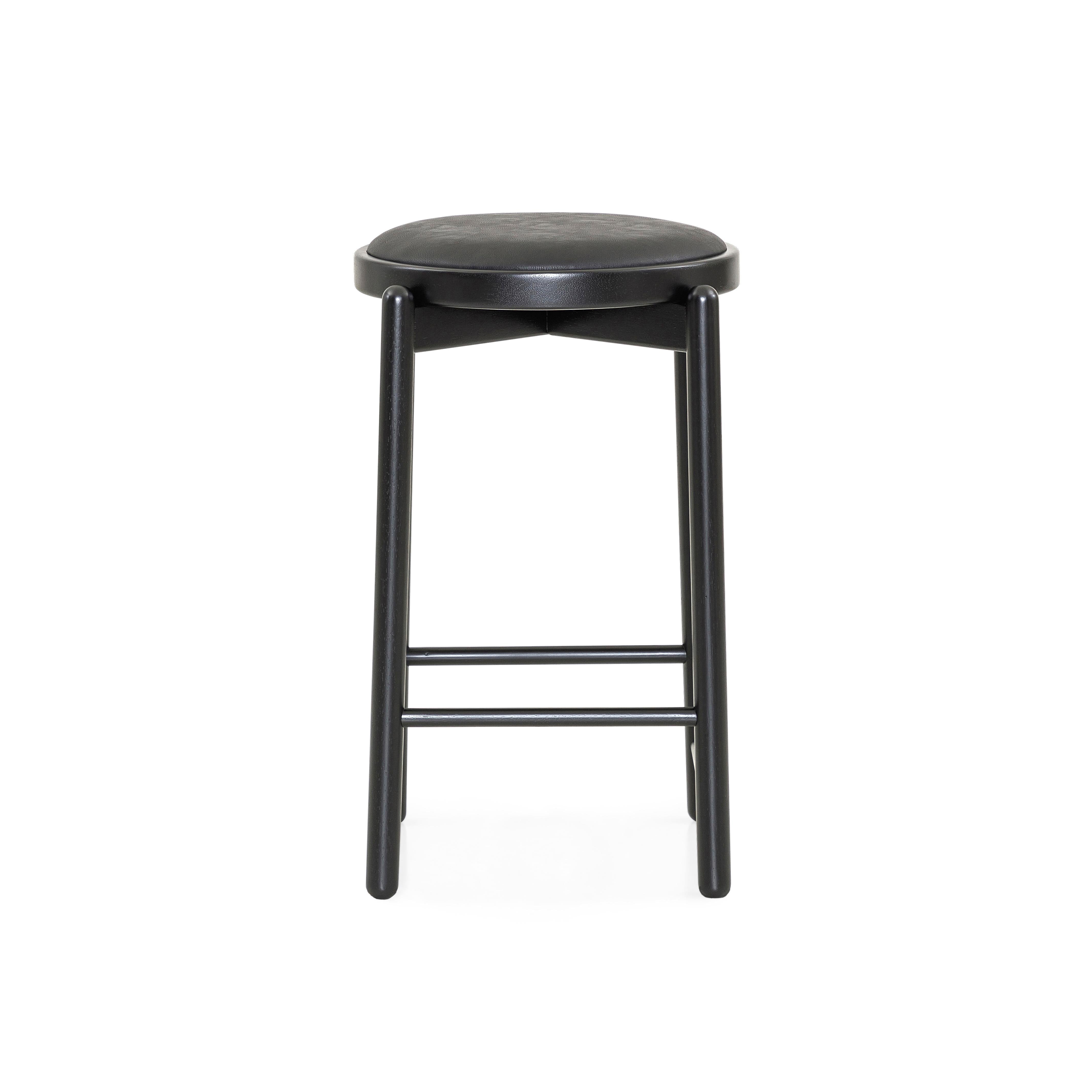 Our Uultis team has designed this Maru counter stool in a black wood base with a matching upholstered black cushioned seat that will stop being only a decoration counter stool to become part of the day-to-day lives of those who experience enriching