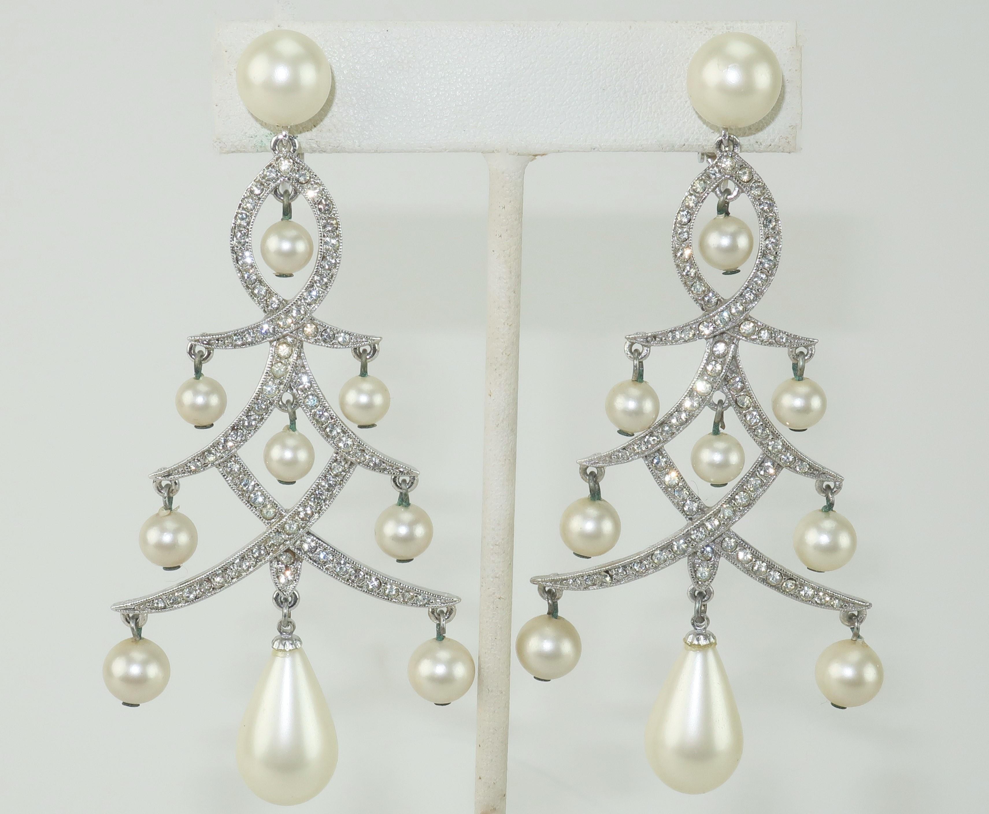 1950’s Marvella chandelier earrings with screwback clip on hardware.  Silver tone metal is embellished with crystal rhinestones and teardrop shaped faux pearls in a Christmas tree shape making these the perfect accessory for the holidays. 