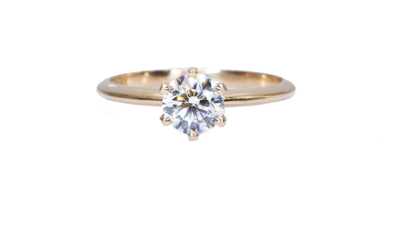 A magnificent classic solitaire ring with a dazzling 1 carat round brilliant natural diamond in J IF. The jewelry is made of 18K Yellow Gold with a high-quality polish. The main stone is engraved with a laser inscription and has a GIA certificate