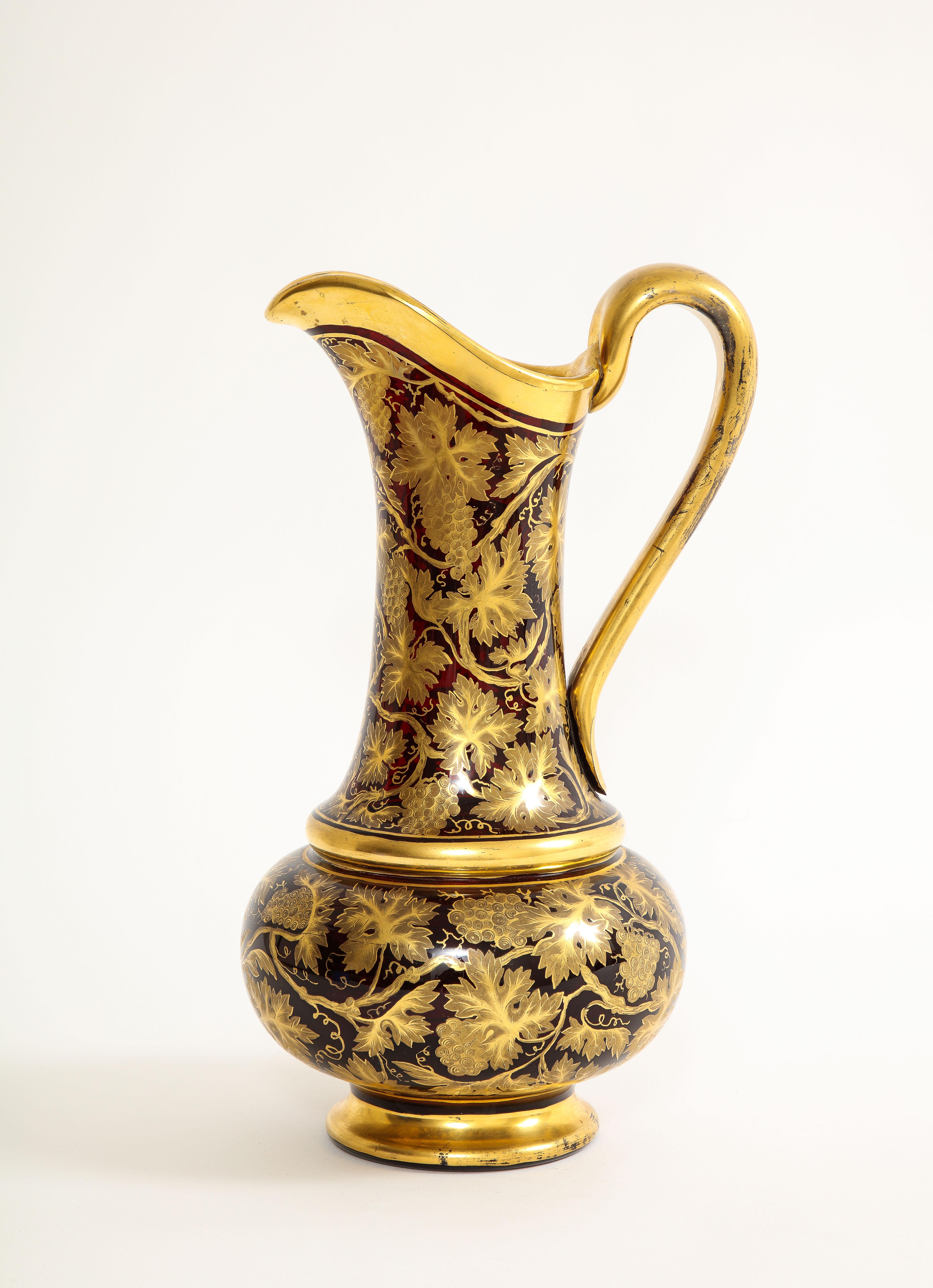 A Marvelous 19th century Bohemian Red Crystal and 24k Gold Decorated Ewer/Water Jug

Behold, this magnificent 19th century Bohemian Red Crystal Gilt Ewer is a true masterpiece of antique artistry. As you gaze upon this stunning piece, you will be