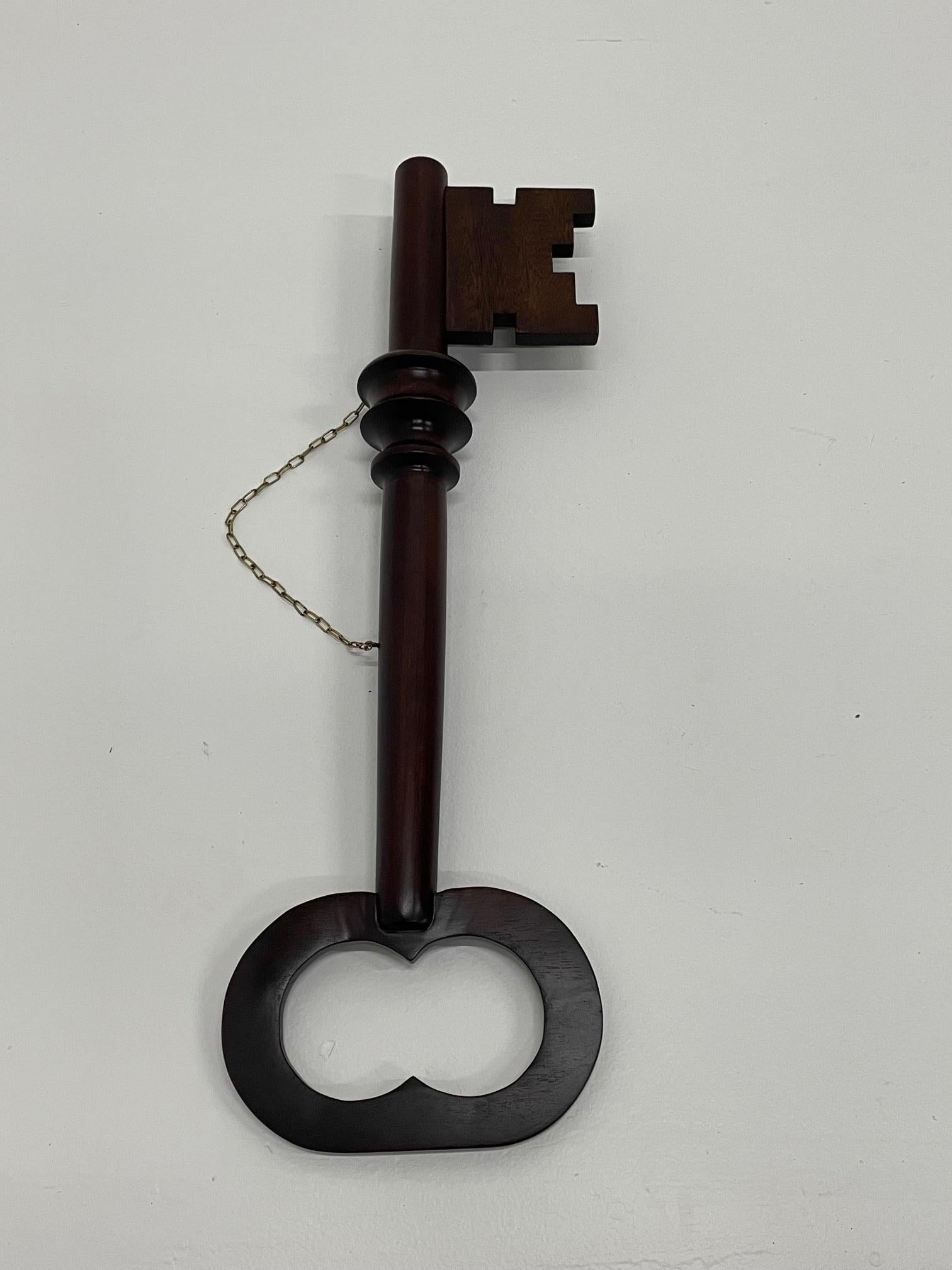 A wonderful early 20th century carved mahogany locksmith trade sign in the shape of a large key. Makes an unexpected piece of wall art as a found object with tons of character.