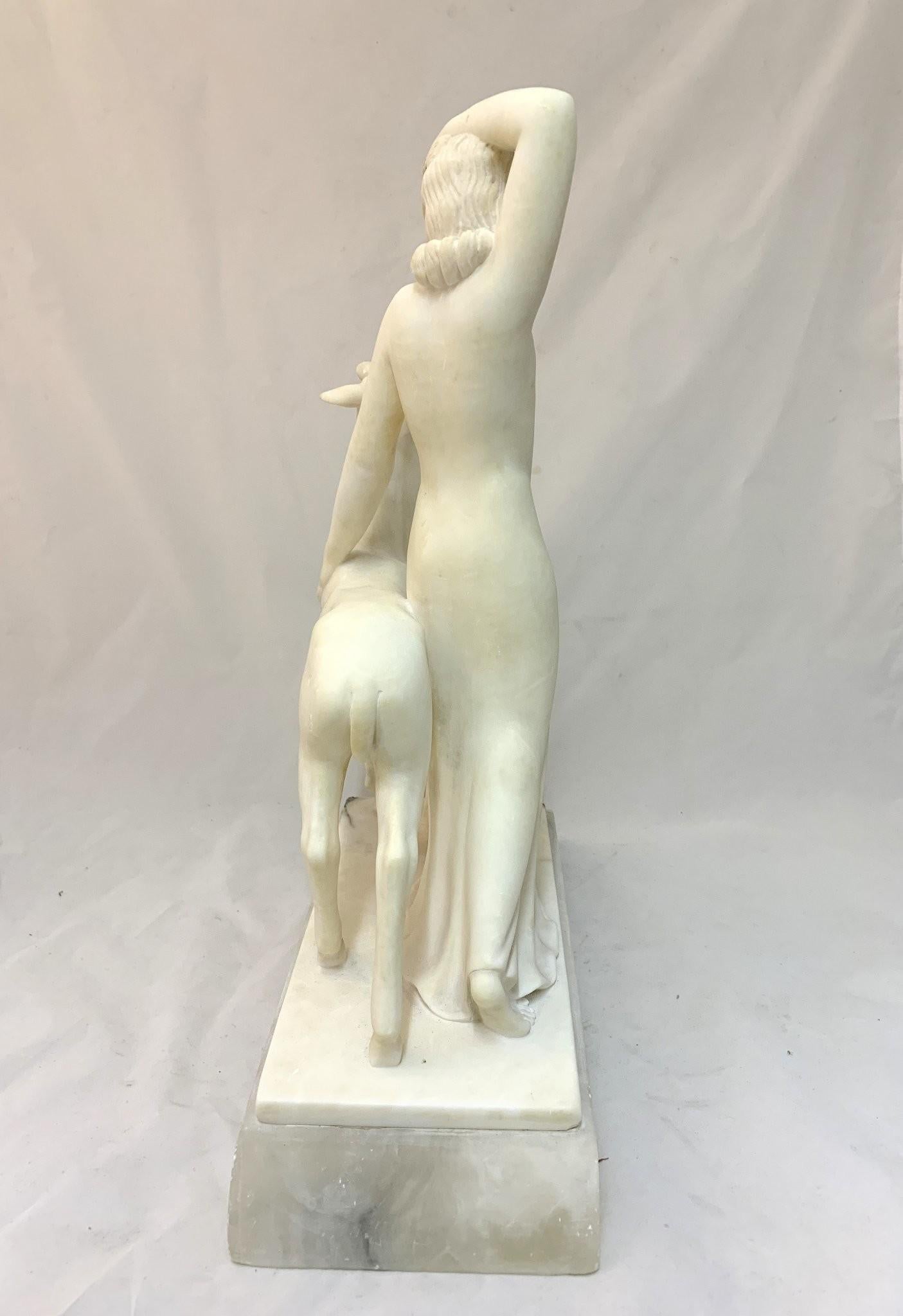 This authentic 1930s Art Deco sculpture depicts a lady with fawn, in a traditional Art Deco manner. It's sculpted out of alabaster and is on a marble base.
It's in good condition, one minor flaw is that the hand was broken off and is reglued and