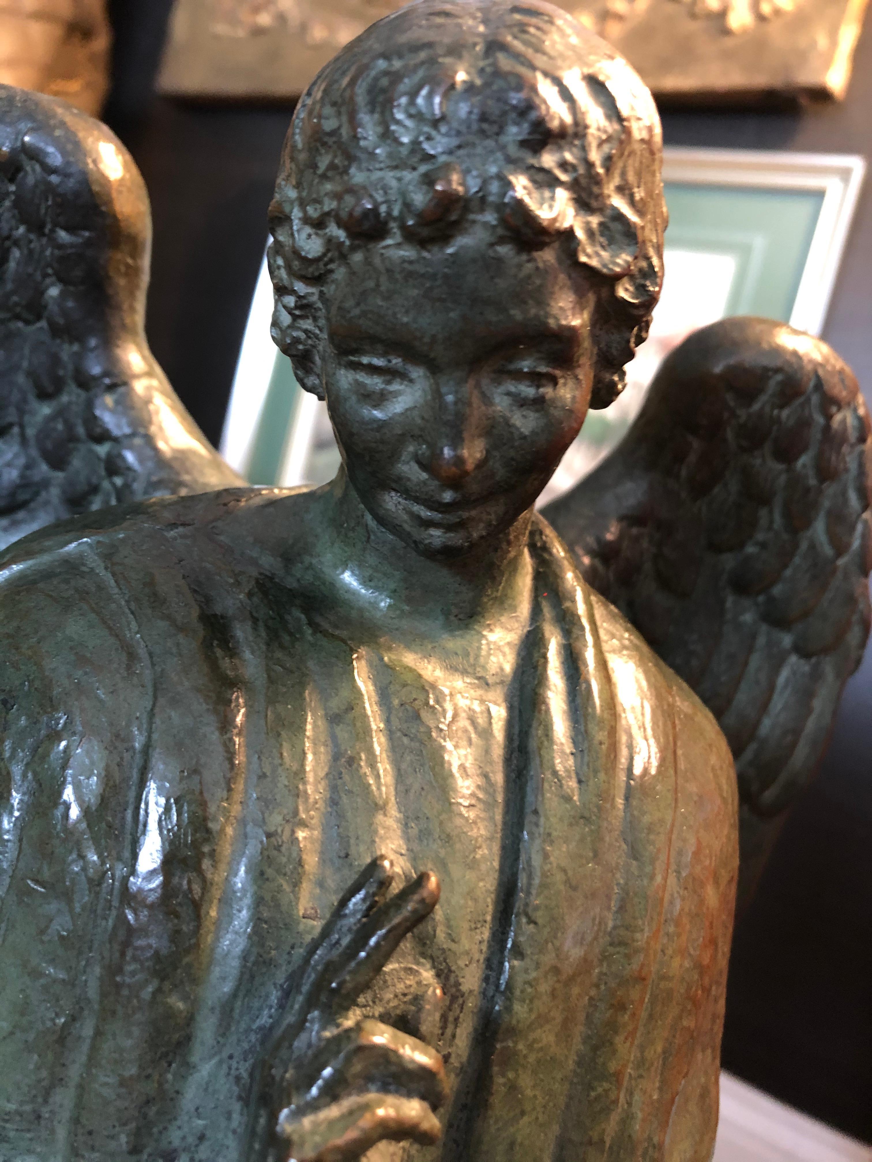 Beautiful cast bronze archangel sculpture having incredible wings and details with a wonderful dark green patina and black marble base. Signed BM Mellon, 1947.
  