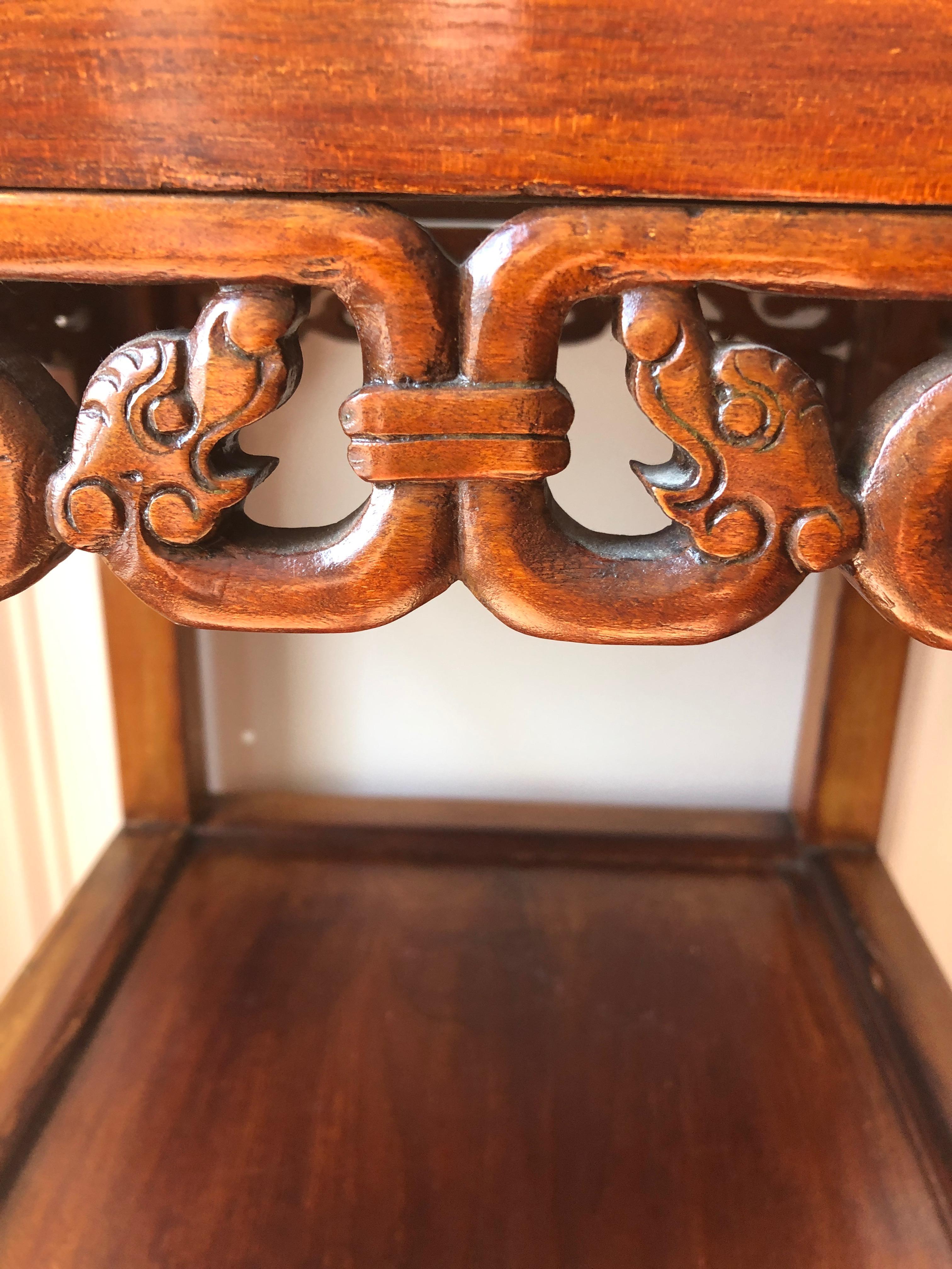 A beautiful Chinese two tier elm side table or nightstand having handsome fretwork with dragon heads and gorgeous grain to the wood.
Bottom tier 16.5 from the ground.