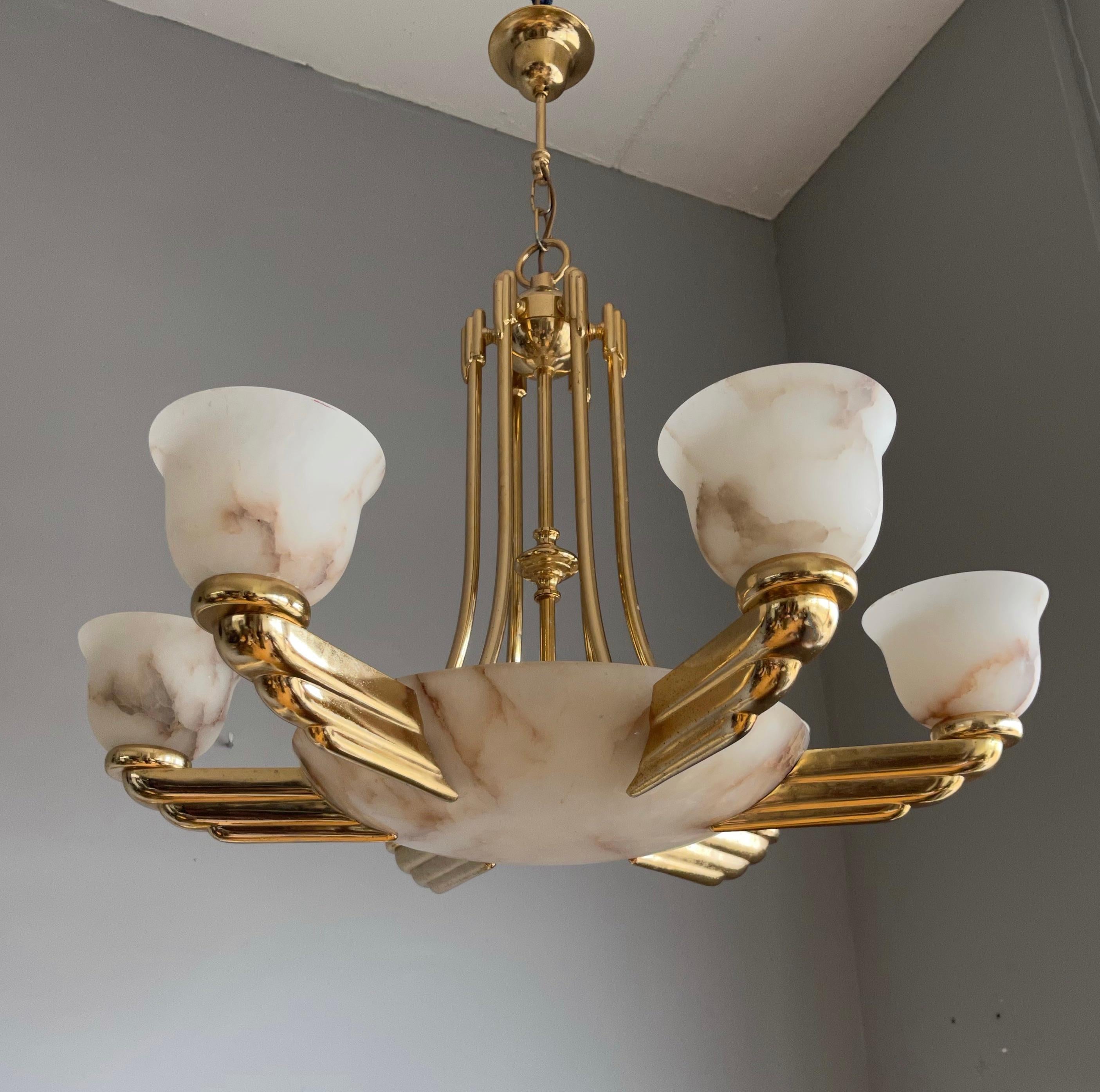 Striking and exclusive, 1970s made light fixture for the perfect Deco atmosphere.

If you are looking for a remarkable light fixture to grace your living space then this vintage Art Deco style chandelier from circa 1970 could very well be perfect.