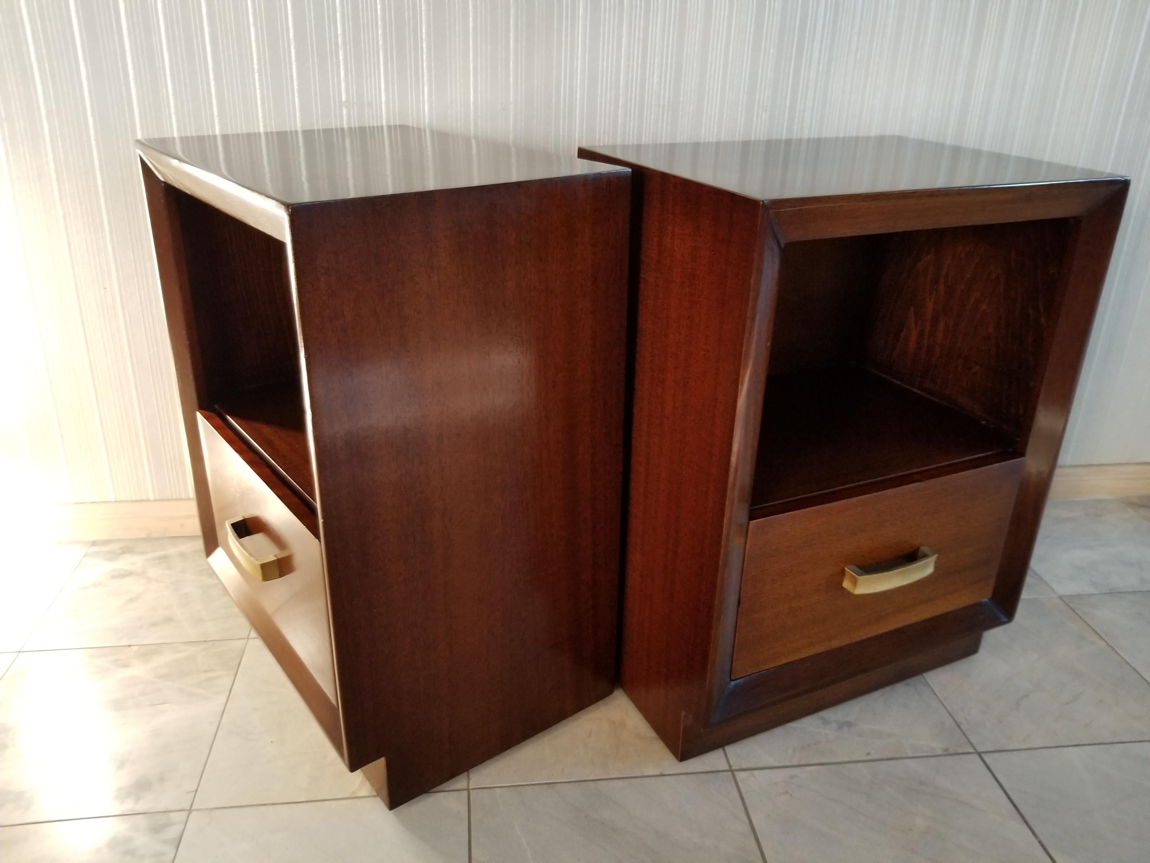 Elegance of the midcentury 1950s by famed high end retailer John Stuart of Grand Rapids, Michigan and New York; maker's metal label affixed.
Designed with spacious drawer and cubby area. Selling as a pair.
Retains original elegant brass pull handle