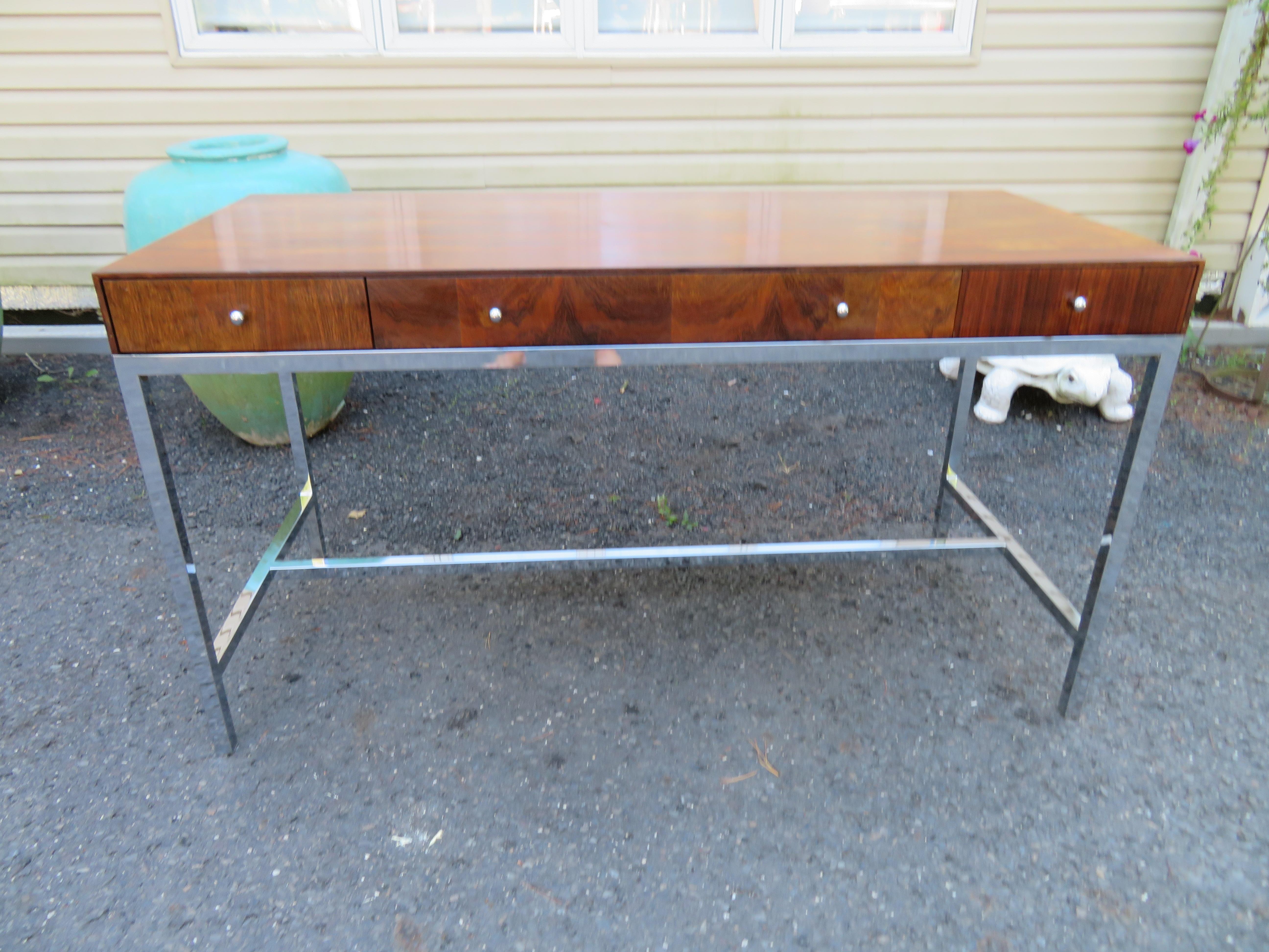 Marvelous Milo Baughman style Mid-Century Modern rosewood desk. This desk retains its original finish with some minor scratches and dings-only ads to authenticity. The chrome base has been polished and looks great. It has a clean design with three