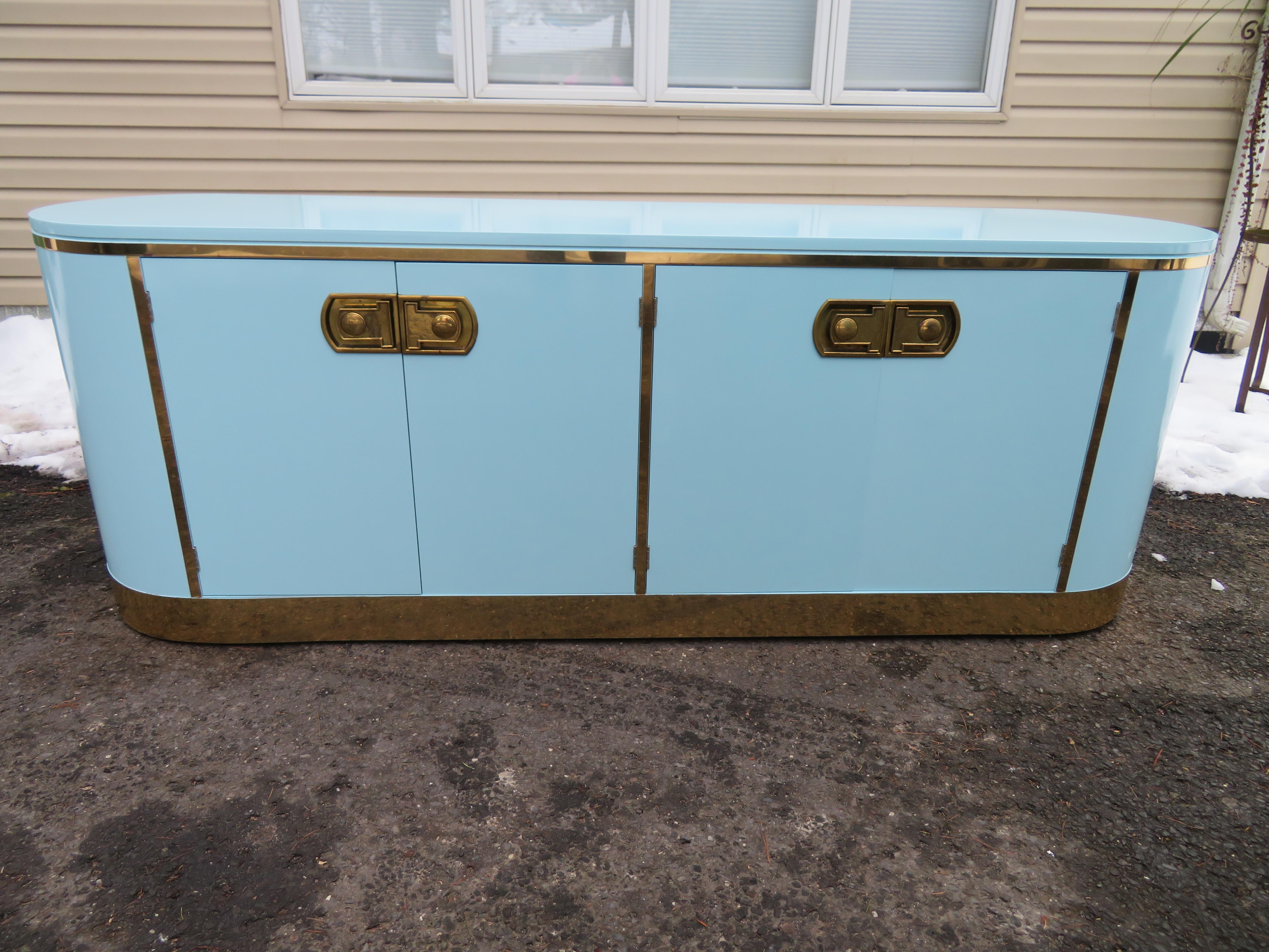 Marvelous Mastercraft Tiffany blue pill shaped credenza. This piece is to die for fabulous with the newly lacquered finish in a soft tiffany blue. Done inside and out it just looks great from top to bottom. This is one of those pieces you just have