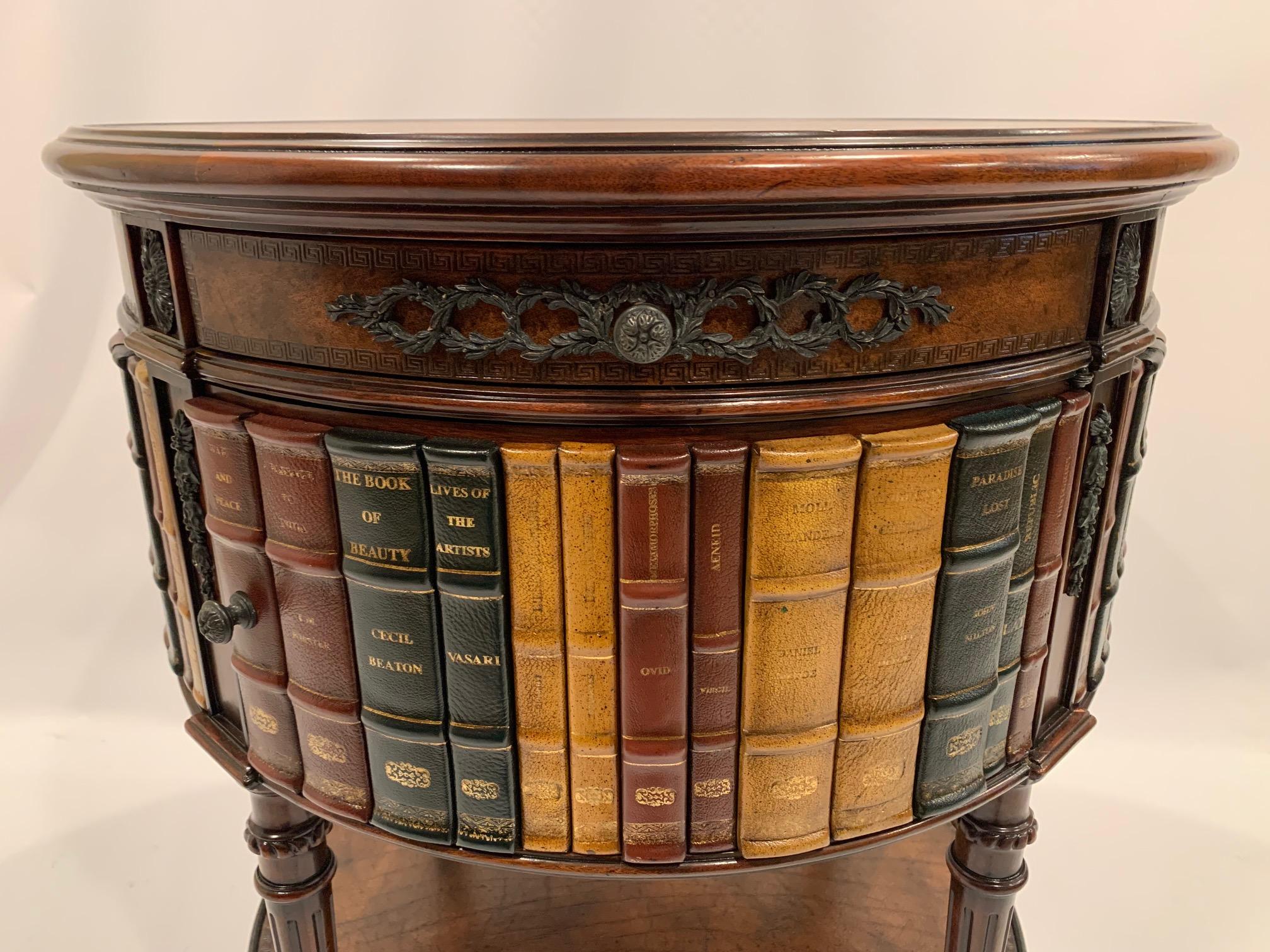 A beautifully designed round trompe l'oeil side table decorated with what looks like leather bound books on the periphery. Table has a single drawer and swing out door that open to storage. Top is a warm caramel tooled leather.
A crowd pleaser and