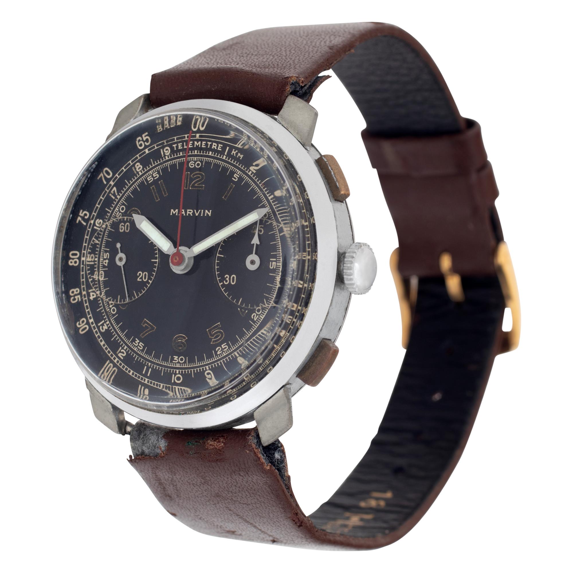 Vintage Marvin chronograph with stainless steel case, stainless steel bezel watch with  brown leather band with tang buckle. Manual wind. Fine Pre-owned Marvin Watch. Certified preowned Vintage Marvin watch is made out of Stainless steel on a Brown