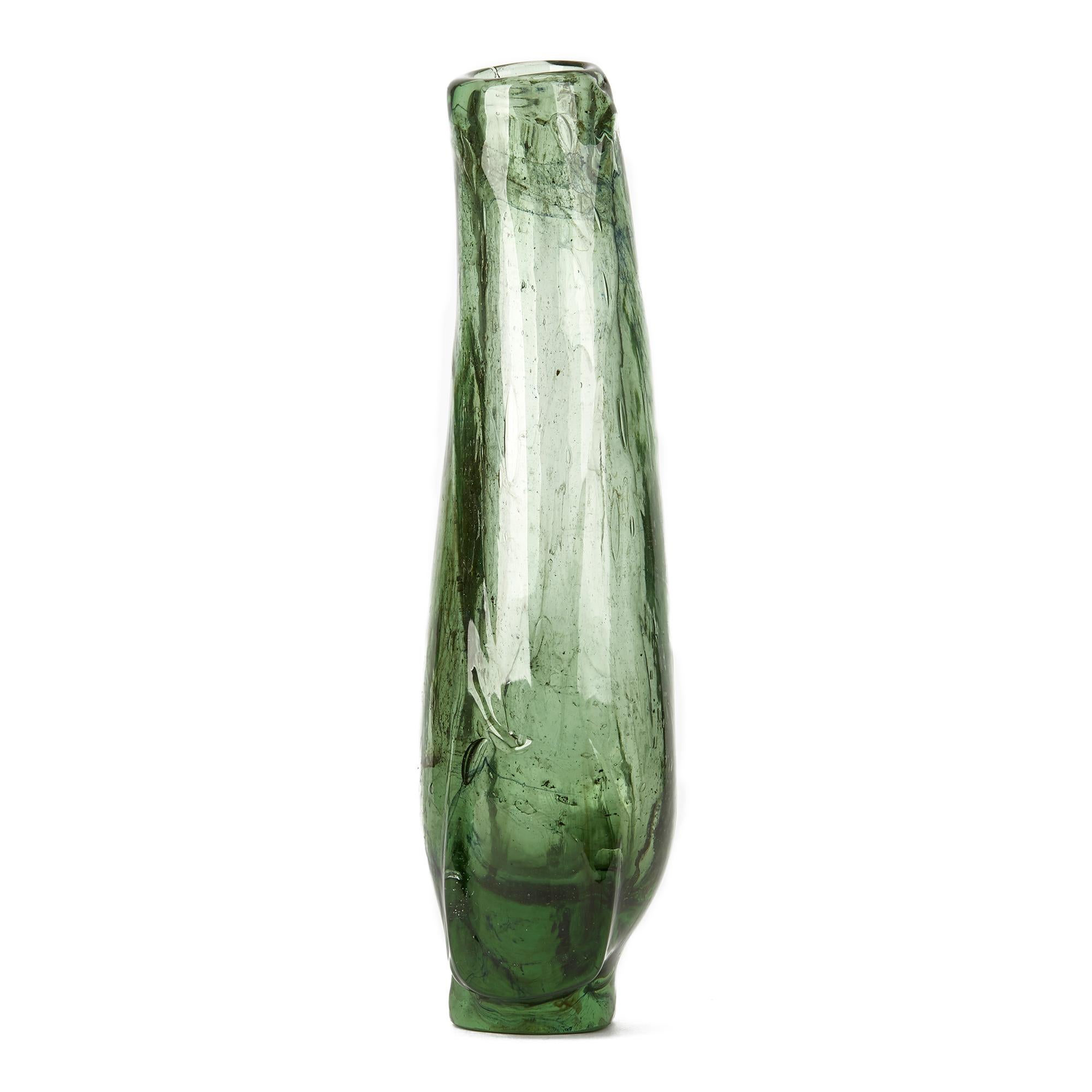 An stylish American art glass vase of tall freeform in shades of green with bubble inclusions by Marvin Lipofsky (1938-2016). The thickly hand blown vase stands on a shaped flat polished base with squared off irregular shaped sides to the lower body