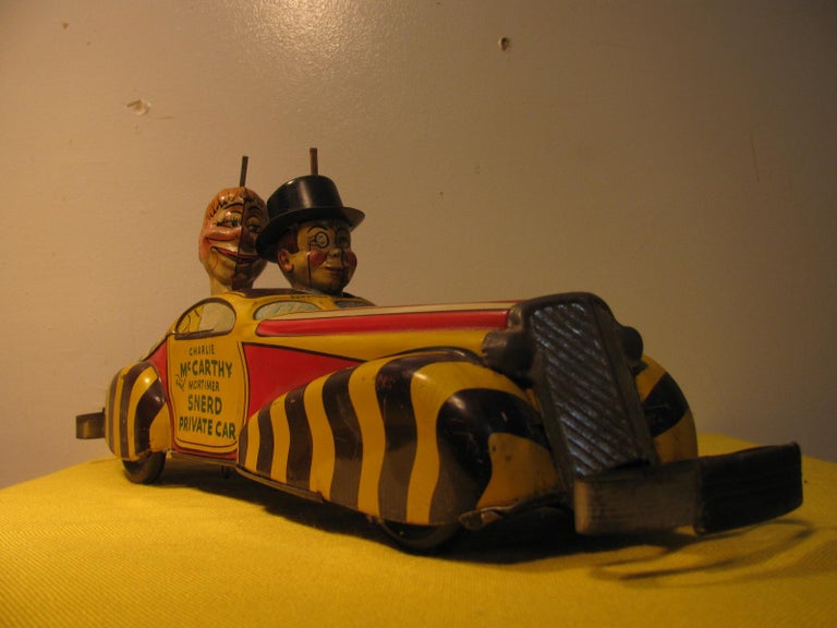 Fabulous tin litho car toy from Louis Marx, circa 1930. Fabulous paint with some paint chips and scrapes but no rust or dents. Clockwork mechanism works very well as the car races forward collides with something and automatically goes into reverse