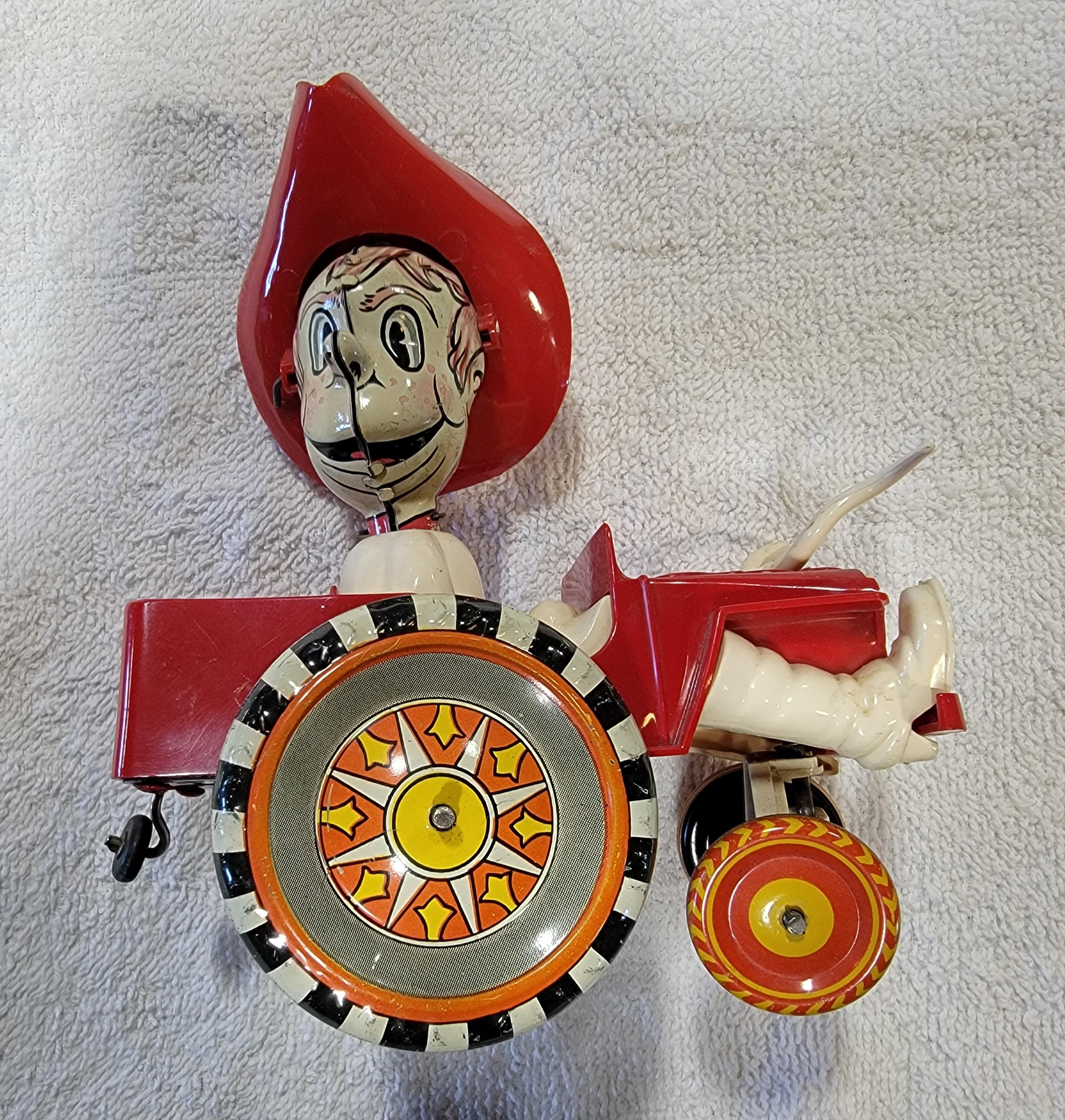 1950's Marx Toys tin lithograph and plastic wind-up Jeep with Cowboy driver. Notice cowboy boots and steer horns mounted to front grill. Excellent, original working condition. 