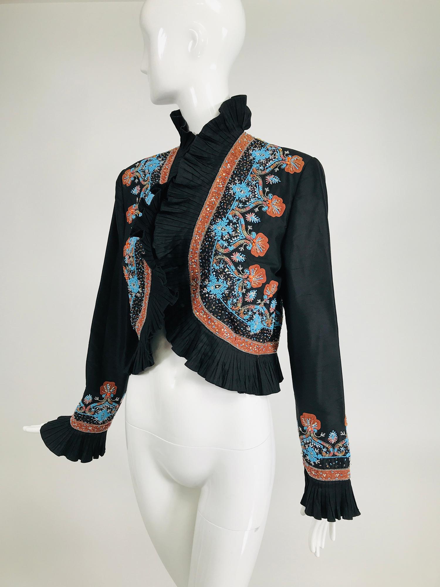 Mary Ann Restivo embroidered black silk taffeta bolero jacket. Beautiful ruffle trim cropped jacket with amazing embroidery, with beads & sequins done in coral and turquoise. The jacket is open at the front with a ruffle edge, long sleeves have