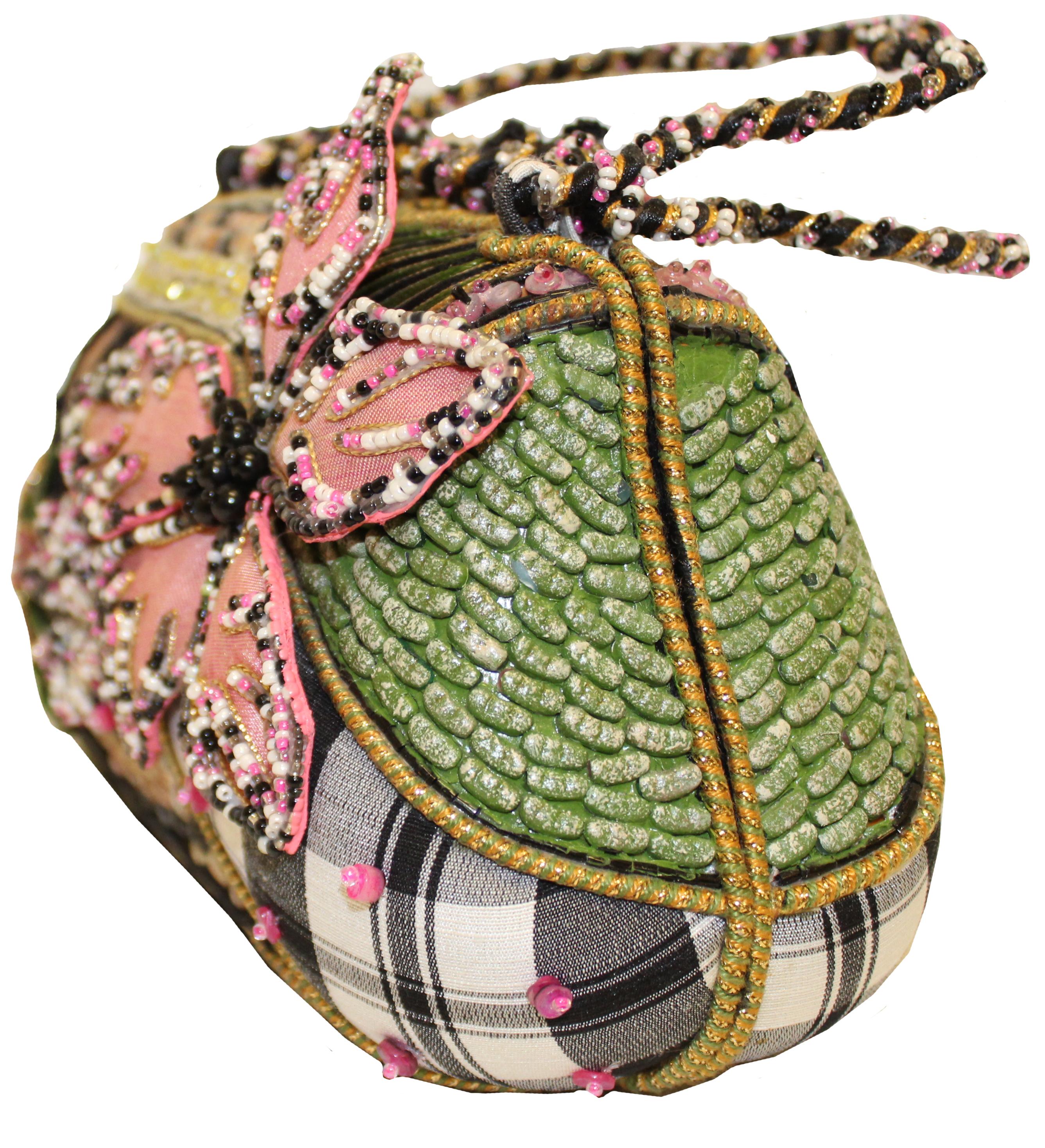 Mary Frances' handbags are instantly recognizable!  Design genius that combines femininity with function.  Whimsical yet elegant.  This structured frame handbag begins with black and white checked canvas and is richly embellished!  Multi color beads
