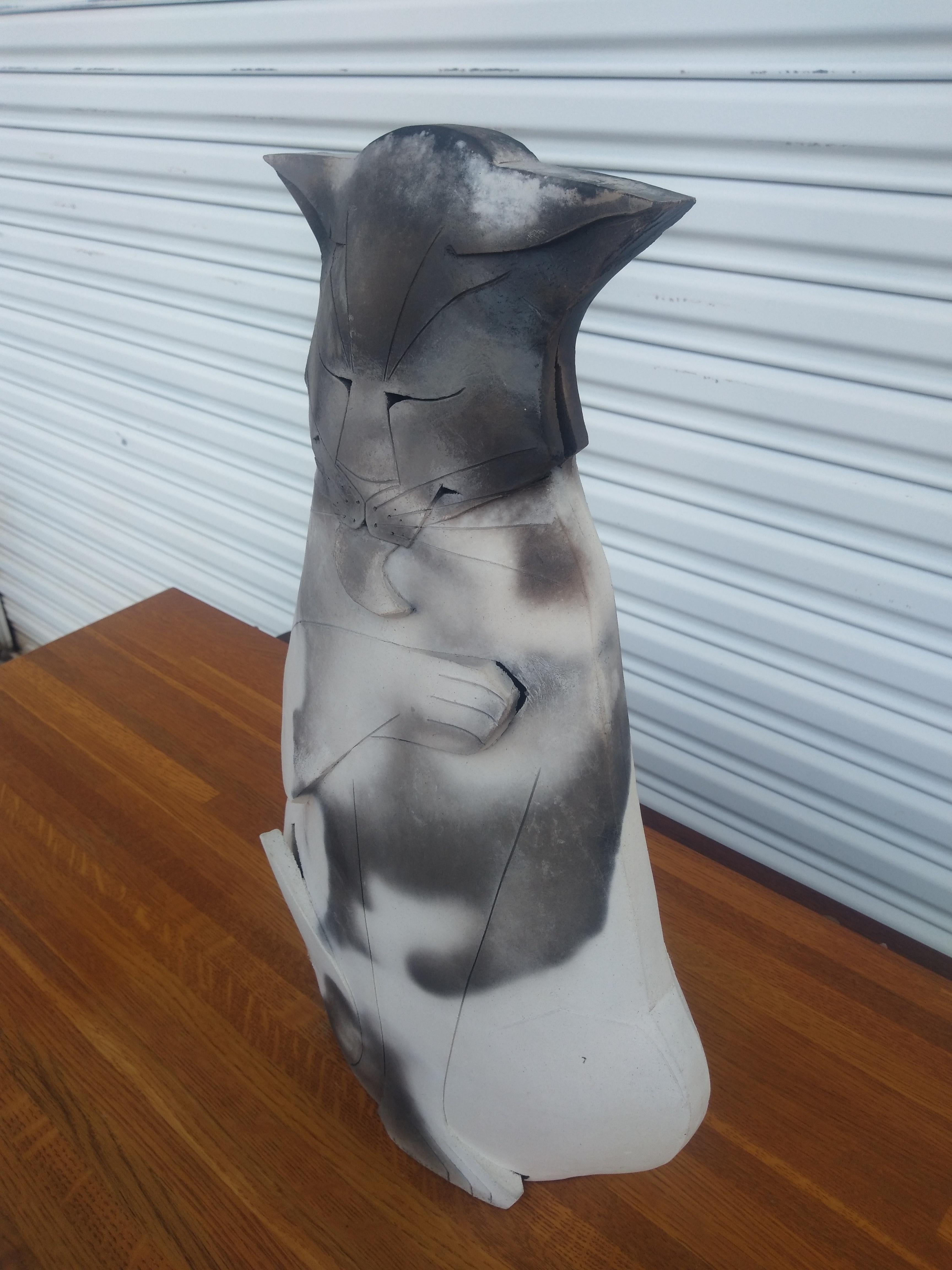 This is a beautiful cat sculpture by Mary Gates Dewey. Made of ceramic, it's designed and sculpted in the whimsical style Mary Gates Dewey is noted for.